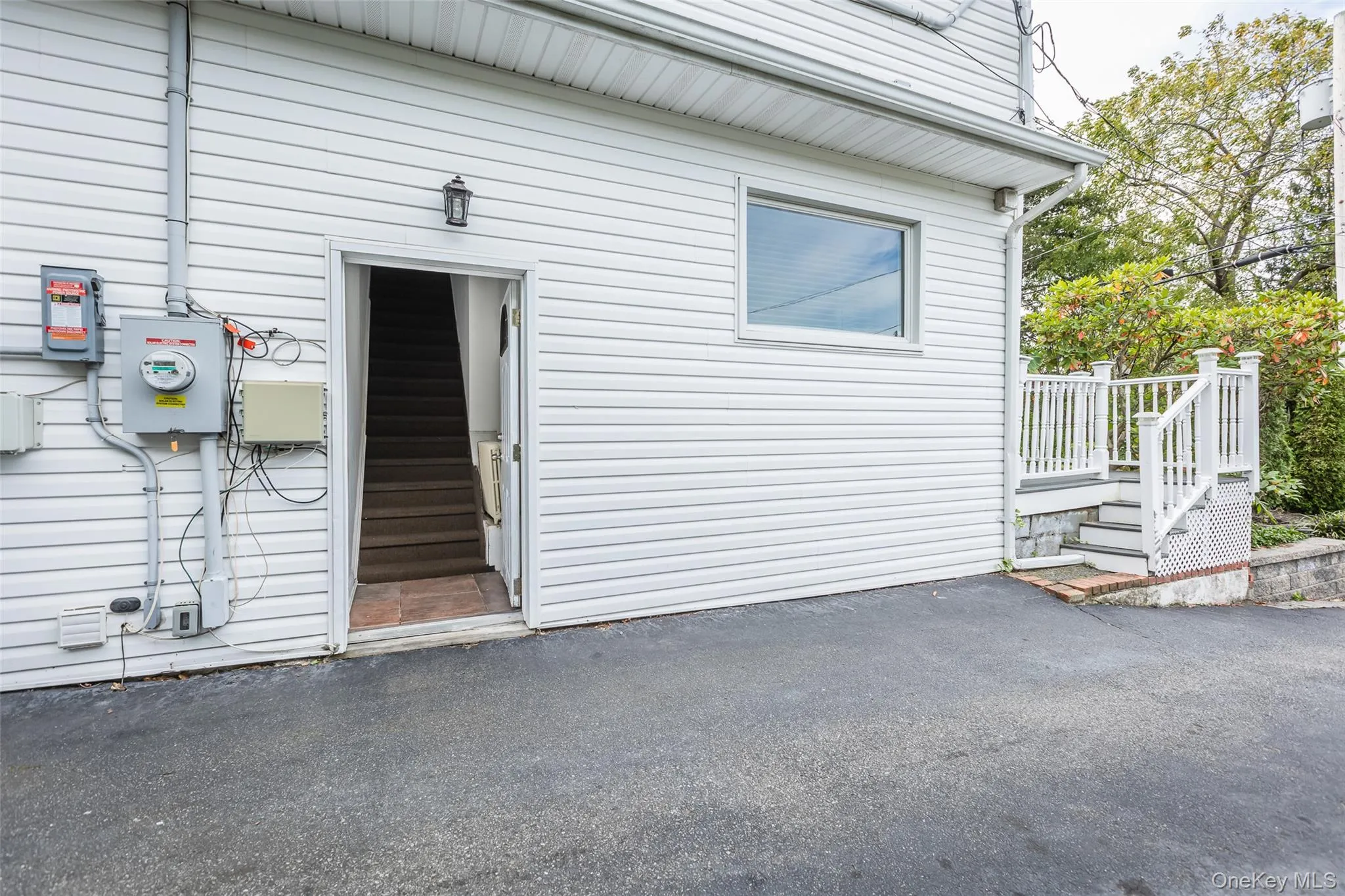 Property entrance with a wooden deck and a patio Property entrance with a wooden deck and a patio
