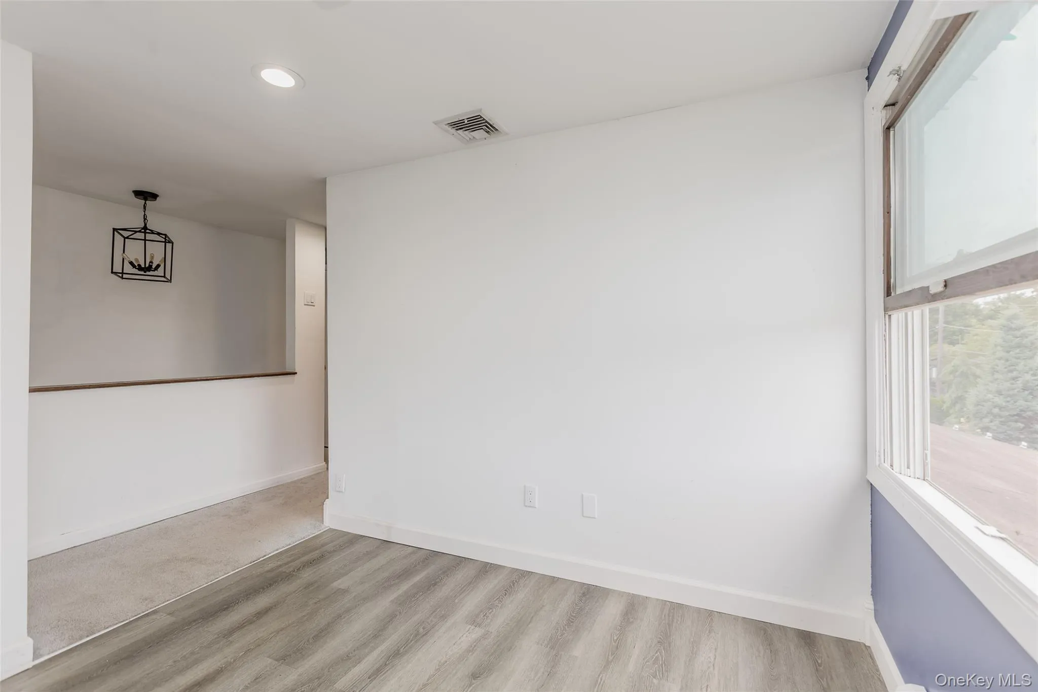 Unfurnished room with wood finished floors and recessed lighting Unfurnished room with wood finished floors and recessed lighting