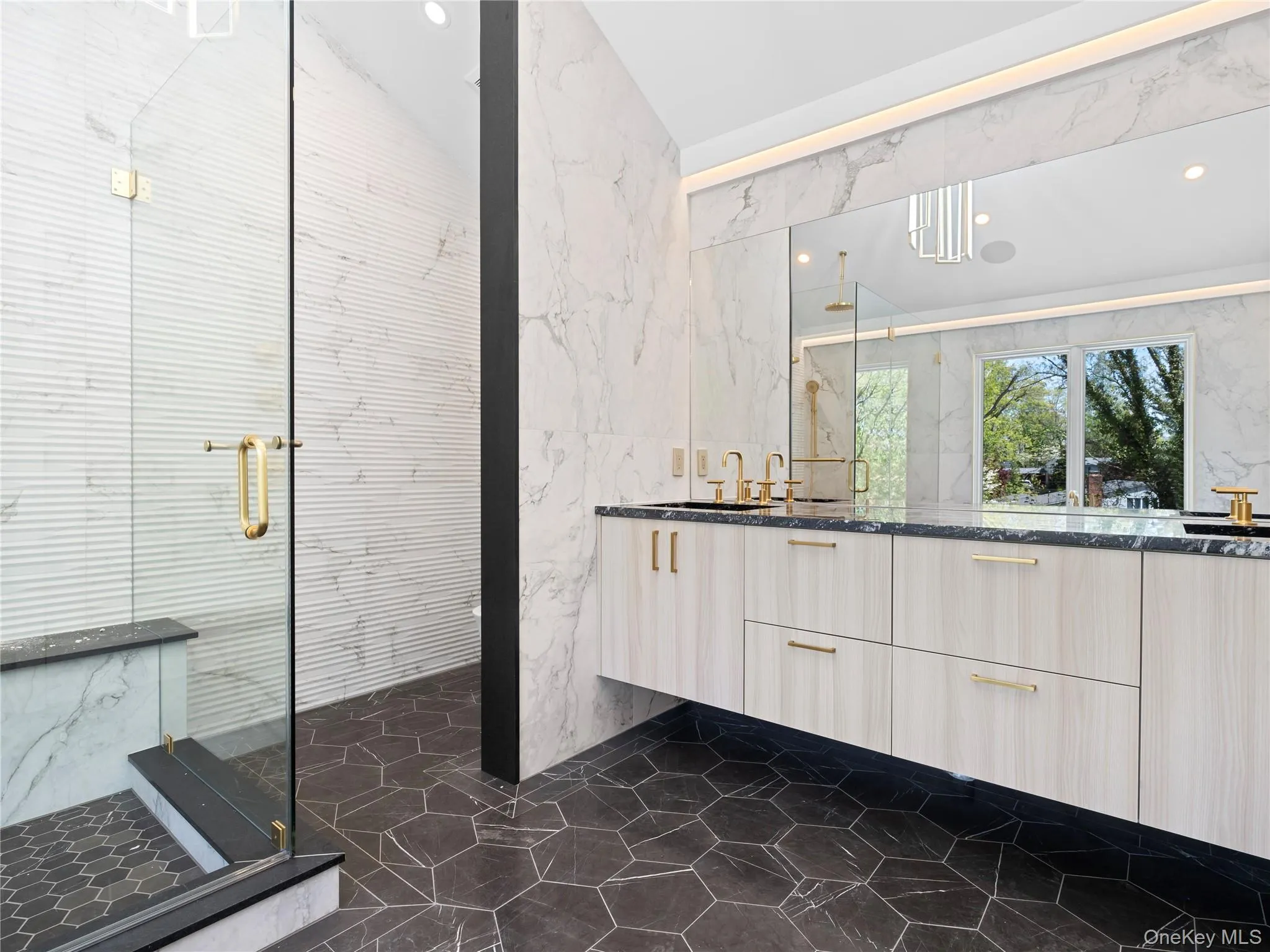 Full bath with tile walls, double vanity, a marble finish shower, recessed lighting, and vaulted ceiling Full bath with tile walls, double vanity, a marble finish shower, recessed lighting, and vaulted ceiling