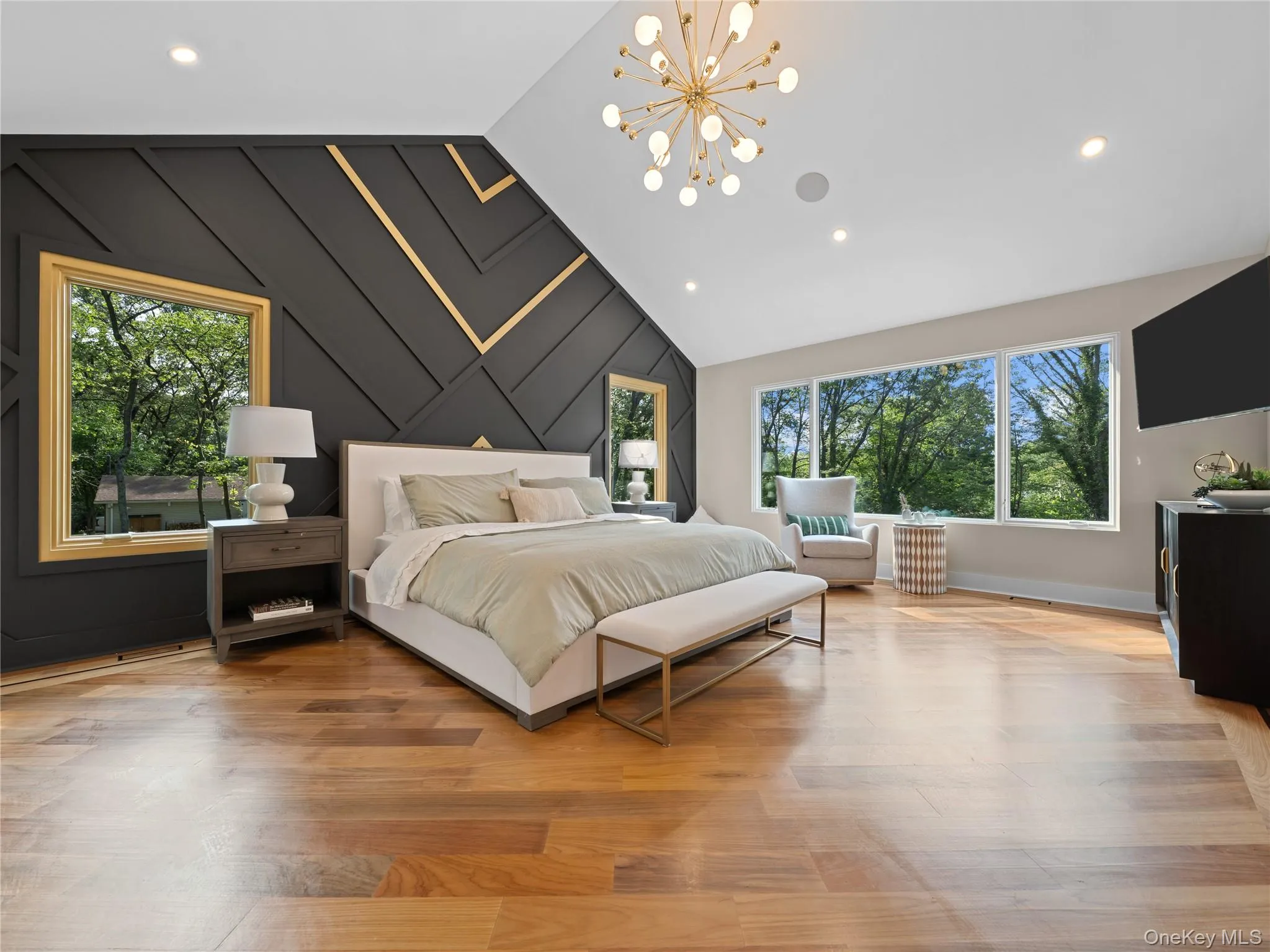 Bedroom with a chandelier, an accent wall, light wood-style floors, lofted ceiling, and wooden walls Bedroom with a chandelier, an accent wall, light wood-style floors, lofted ceiling, and wooden walls