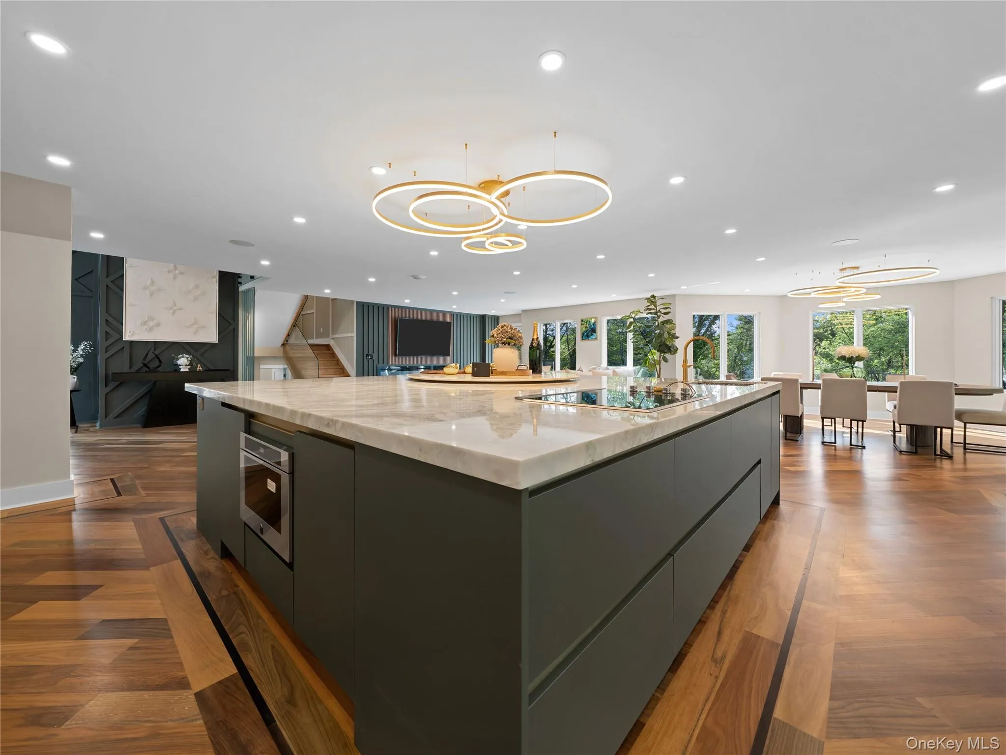 Kitchen featuring modern cabinets, plenty of natural light, recessed lighting, open floor plan, and a spacious island Kitchen featuring modern cabinets, plenty of natural light, recessed lighting, open floor plan, and a spacious island