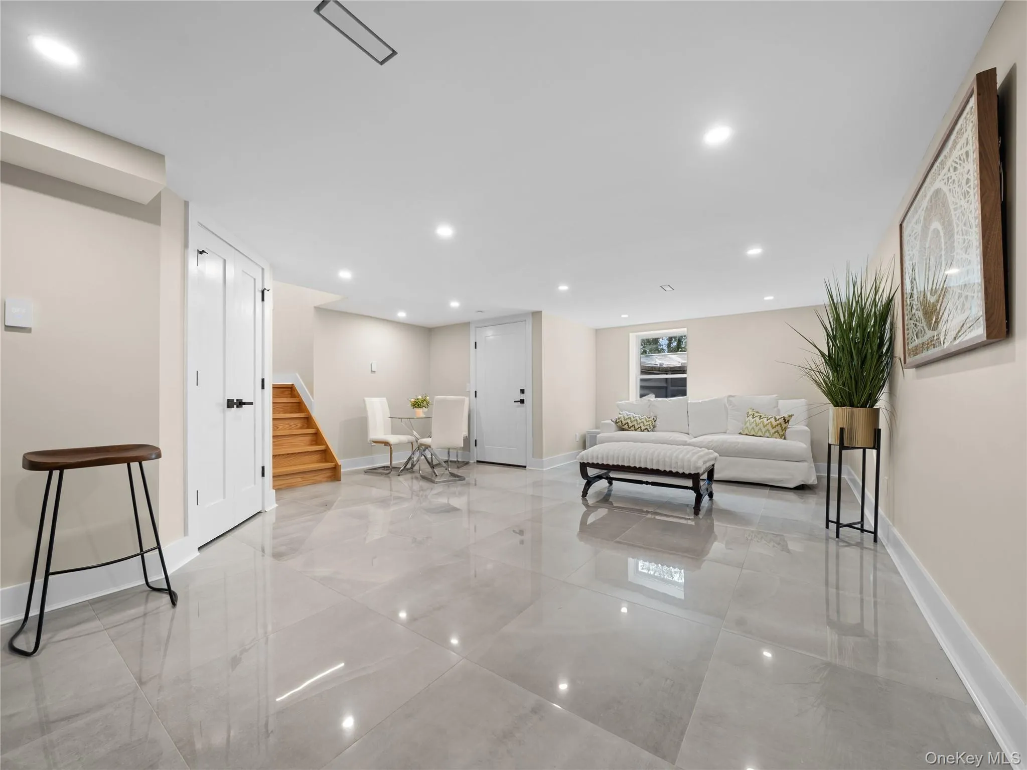 Living area with stairway and recessed lighting Living area with stairway and recessed lighting