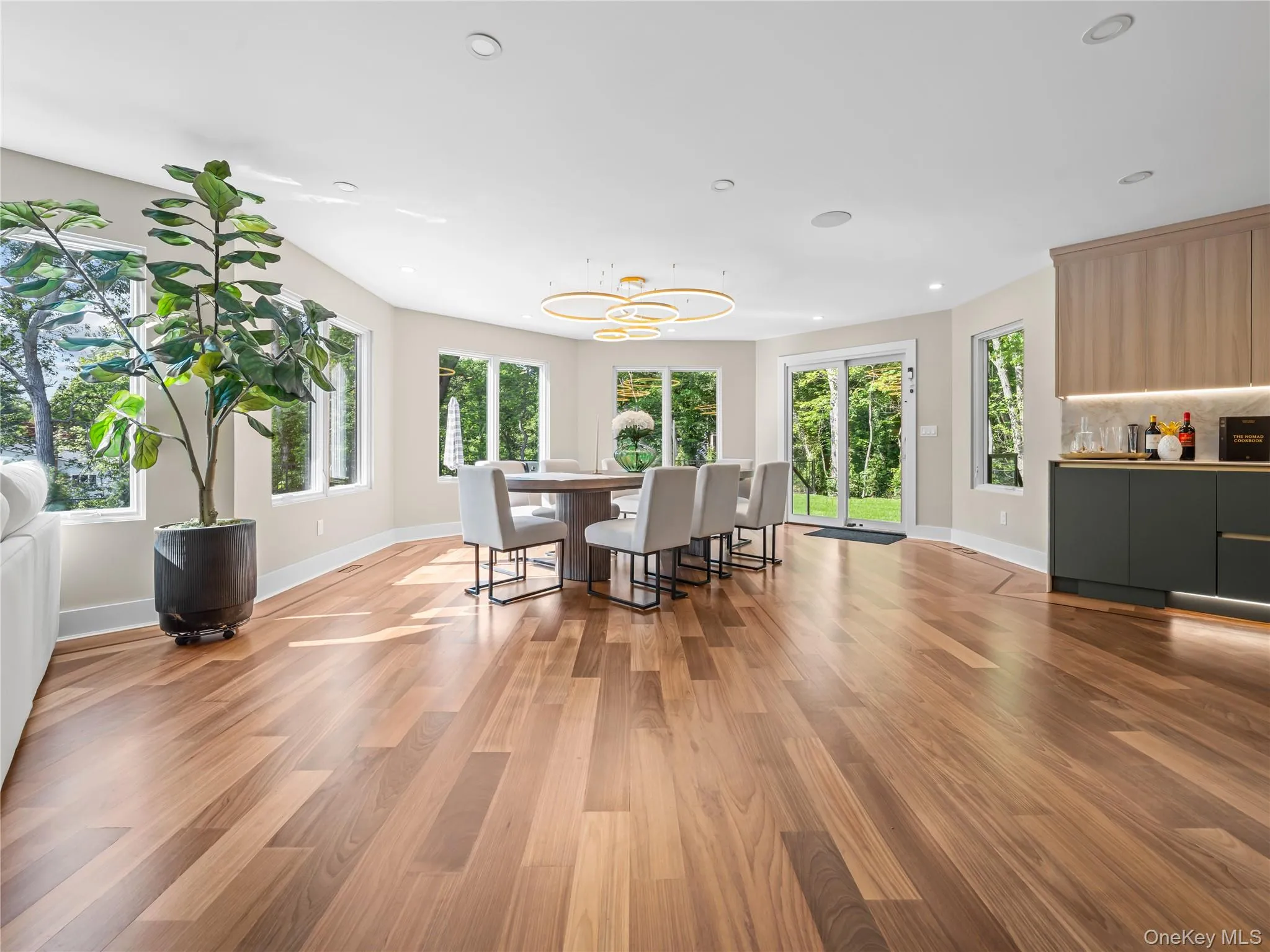 Dining area with light wood finished floors and recessed lighting Dining area with light wood finished floors and recessed lighting