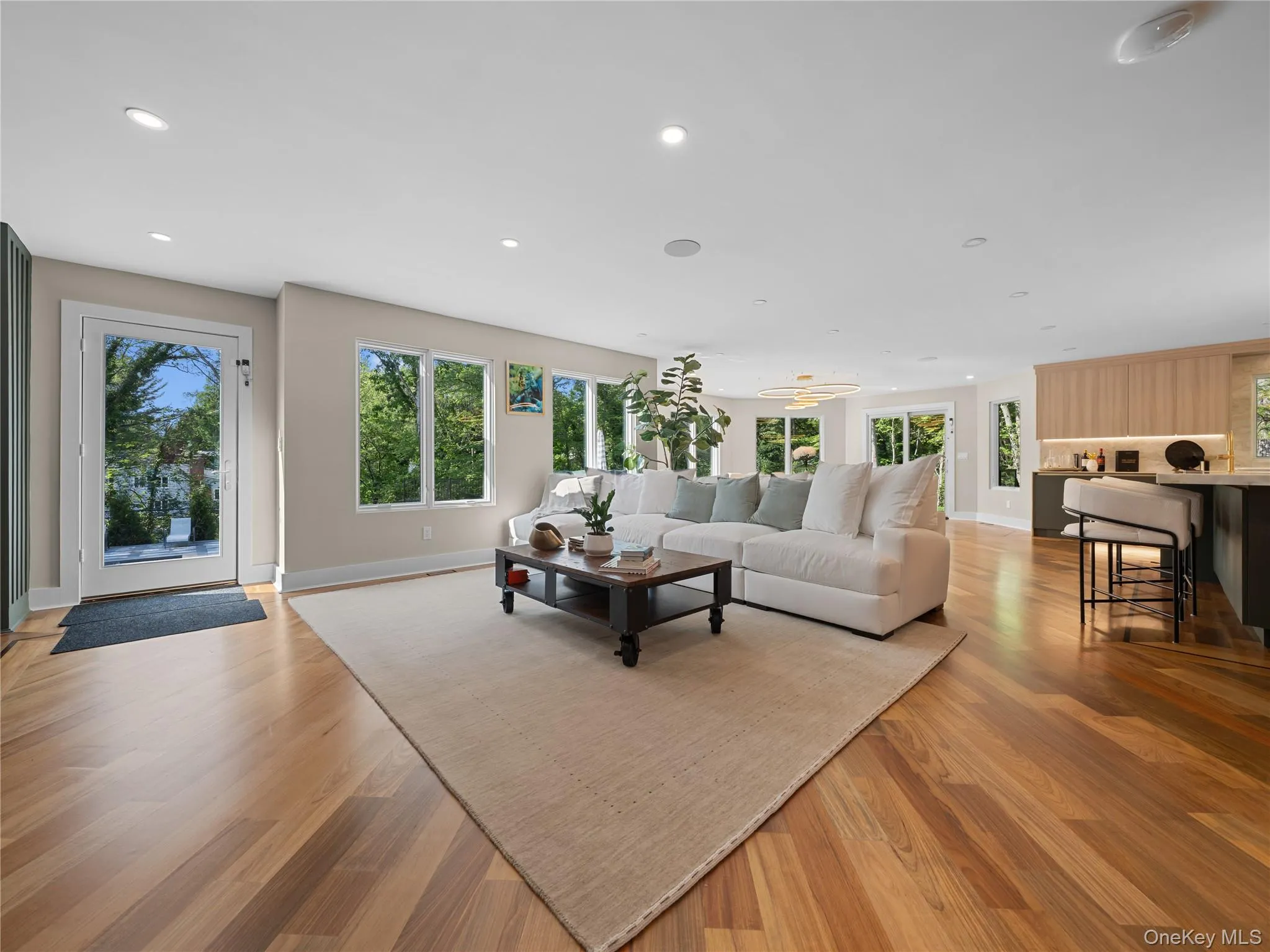 Living room featuring light wood-style floors and recessed lighting Living room featuring light wood-style floors and recessed lighting