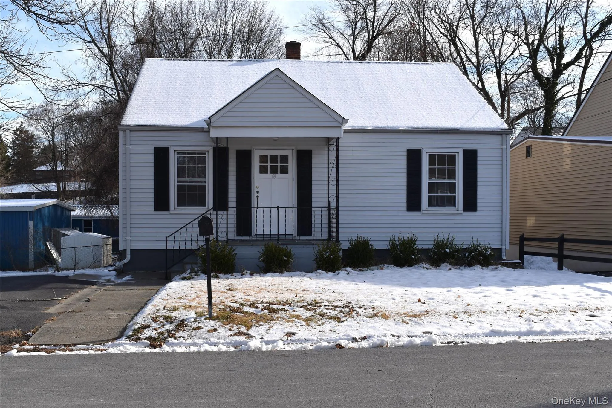 View of front of house with a chimney and covered porch View of front of house with a chimney and covered porch
