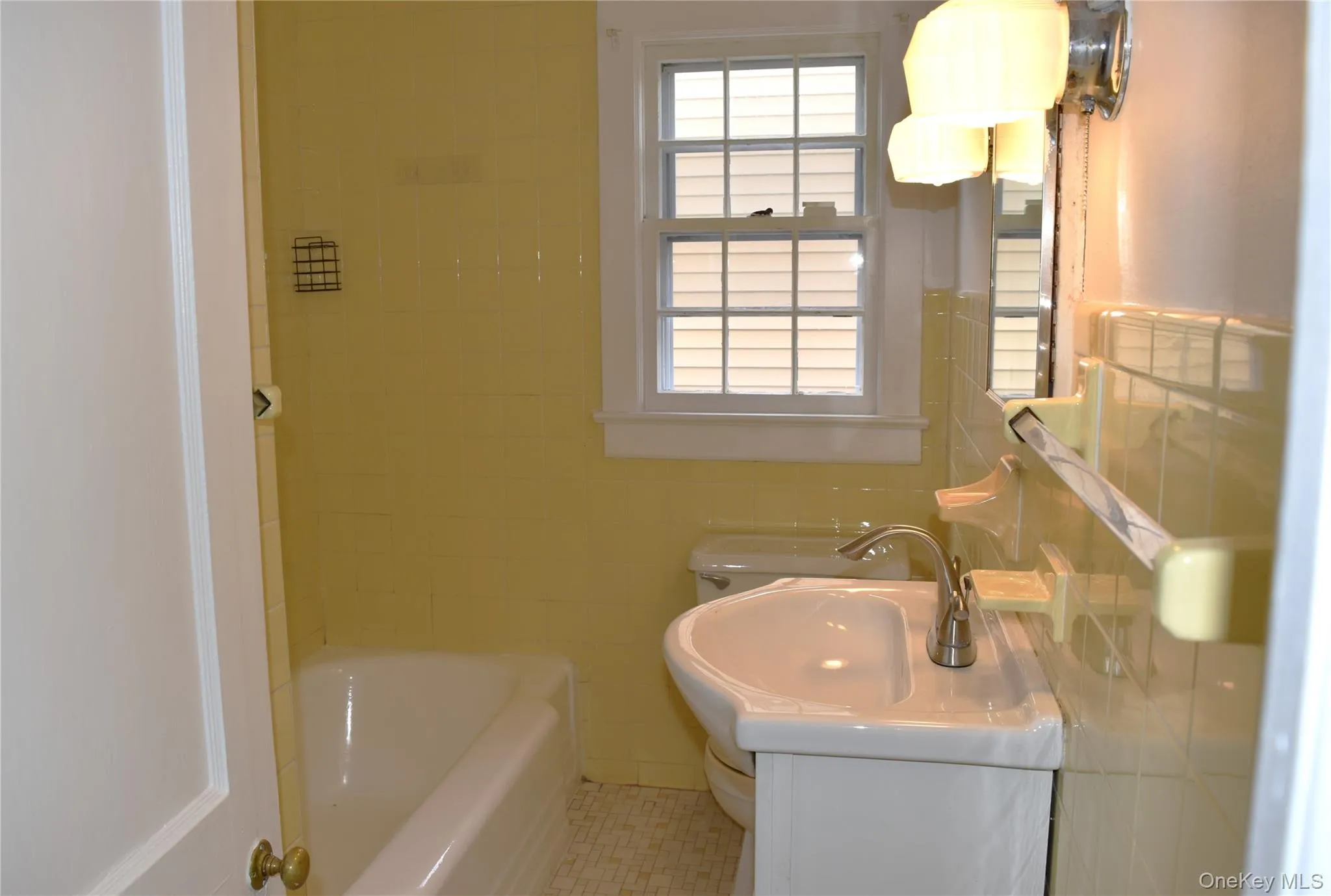 Full bathroom with tile walls and vanity Full bathroom with tile walls and vanity