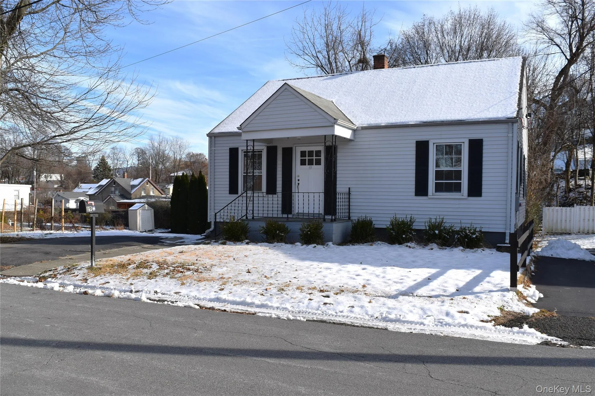View of front of property with covered porch, a chimney, and an outdoor structure View of front of property with covered porch, a chimney, and an outdoor structure
