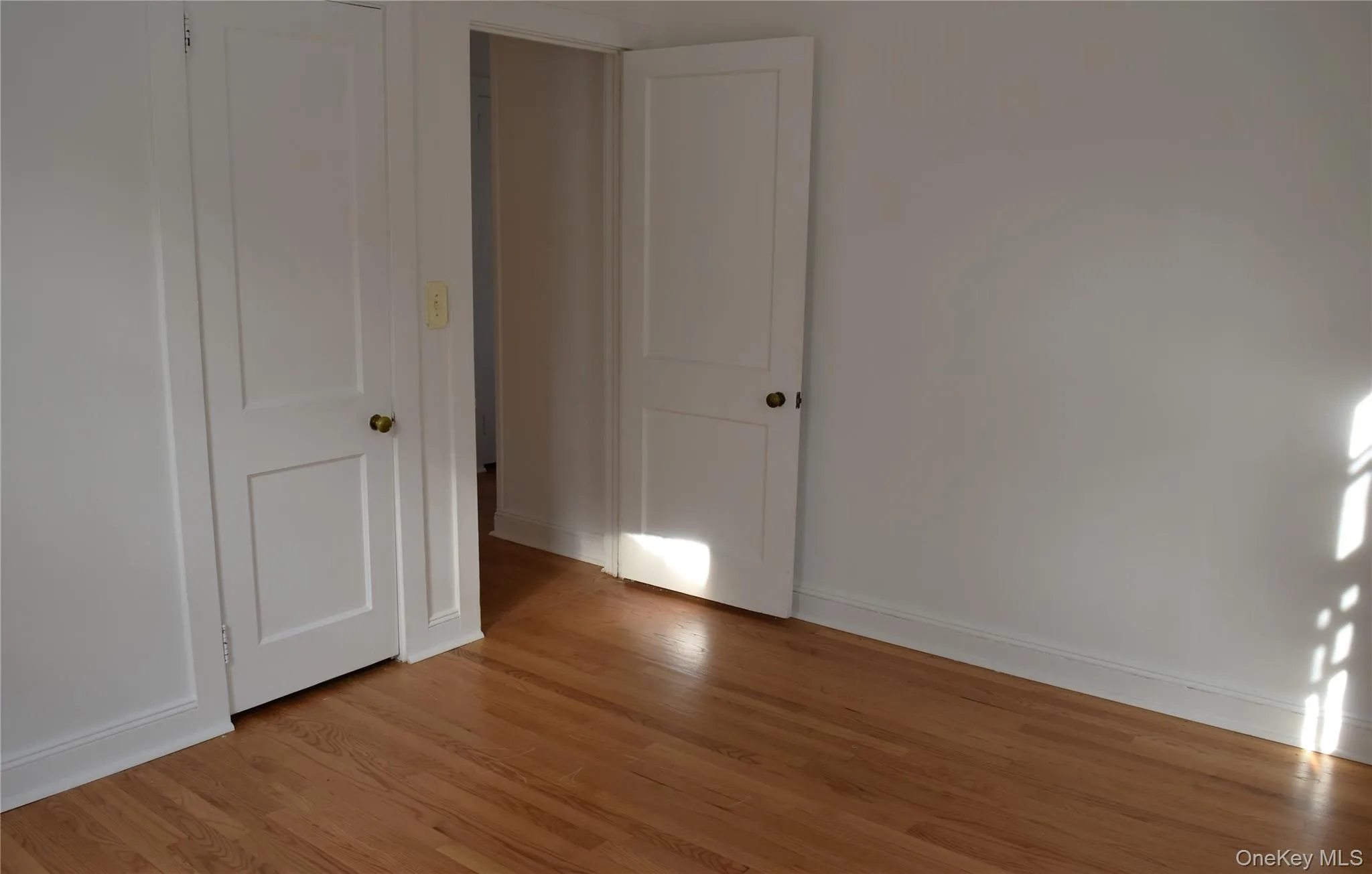 Unfurnished bedroom featuring light wood finished floors and baseboards Unfurnished bedroom featuring light wood finished floors and baseboards