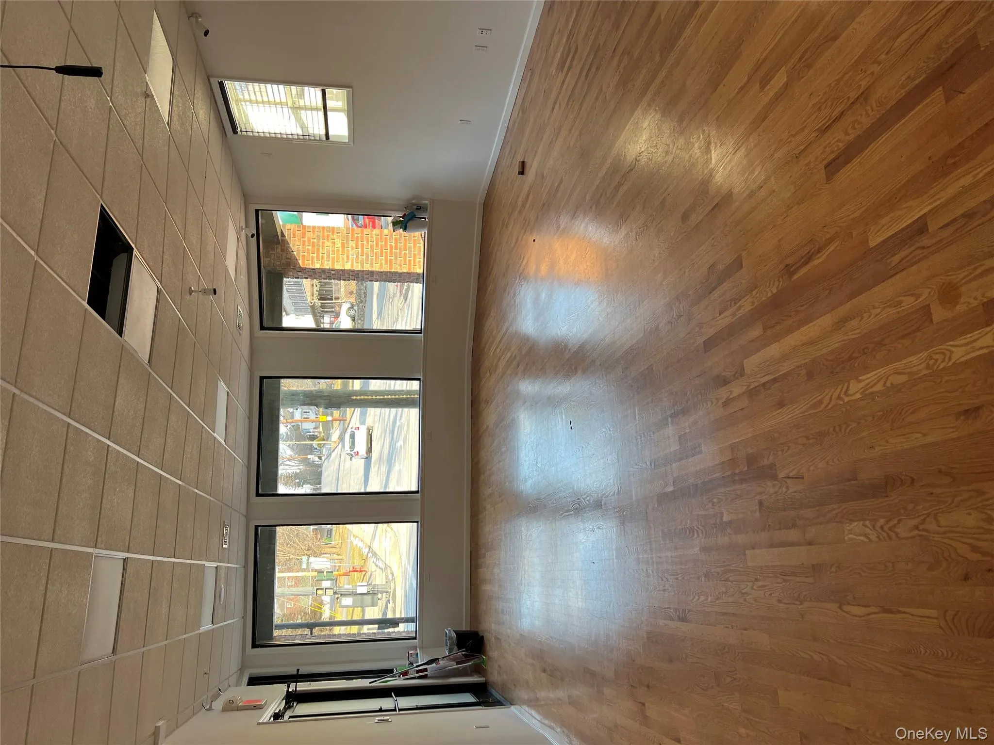 Spare room with a drop ceiling and light wood finished floors Spare room with a drop ceiling and light wood finished floors