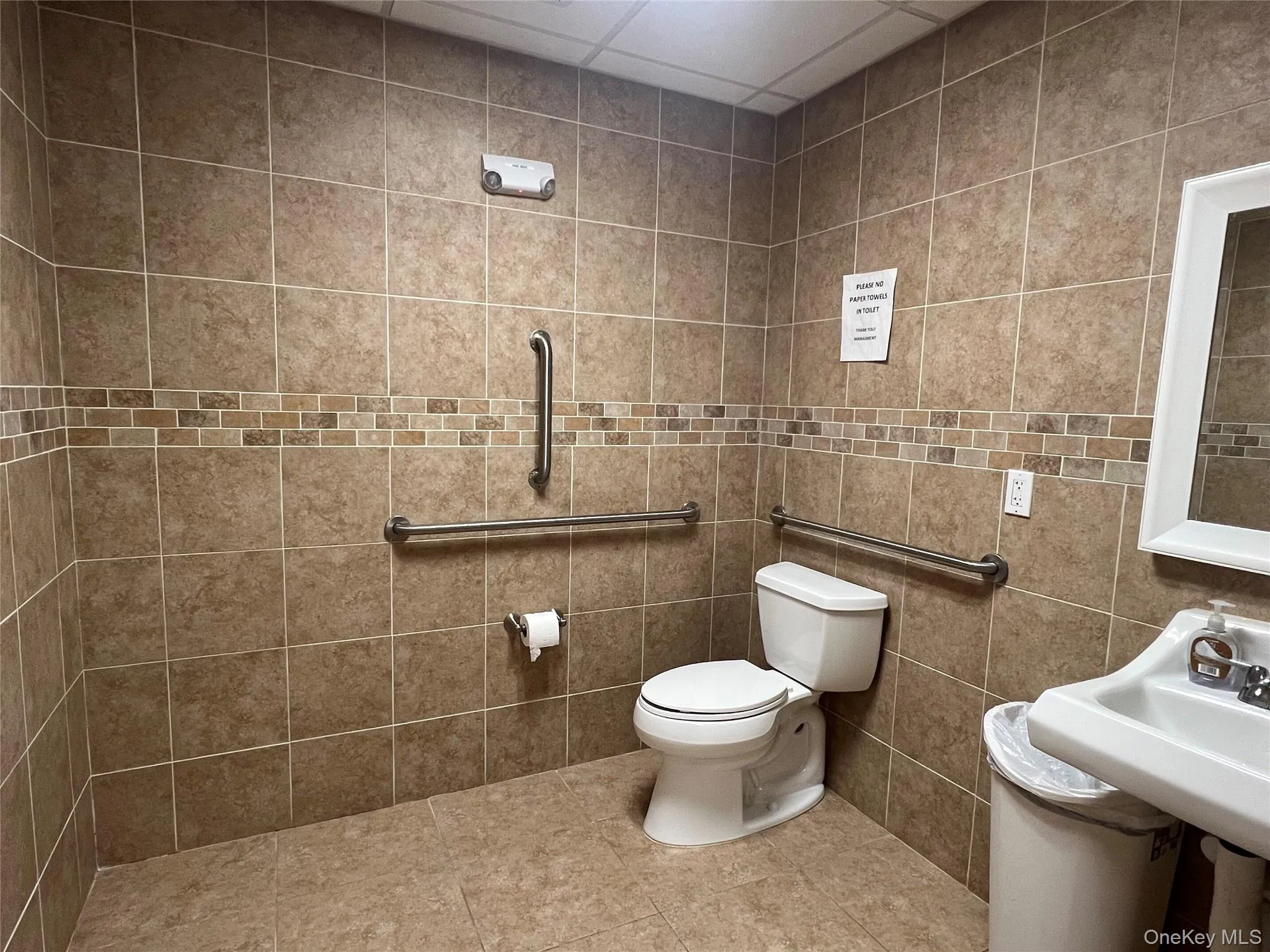Bathroom with toilet and tile patterned floors Bathroom with toilet and tile patterned floors