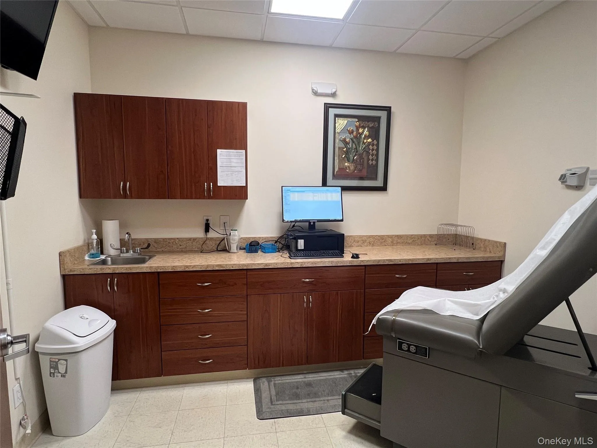 Kitchen featuring a paneled ceiling and dark brown cabinets Kitchen featuring a paneled ceiling and dark brown cabinets
