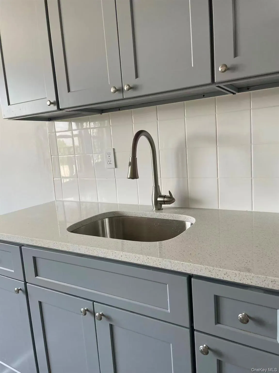 Detailed view of tasteful backsplash and a sink Detailed view of tasteful backsplash and a sink