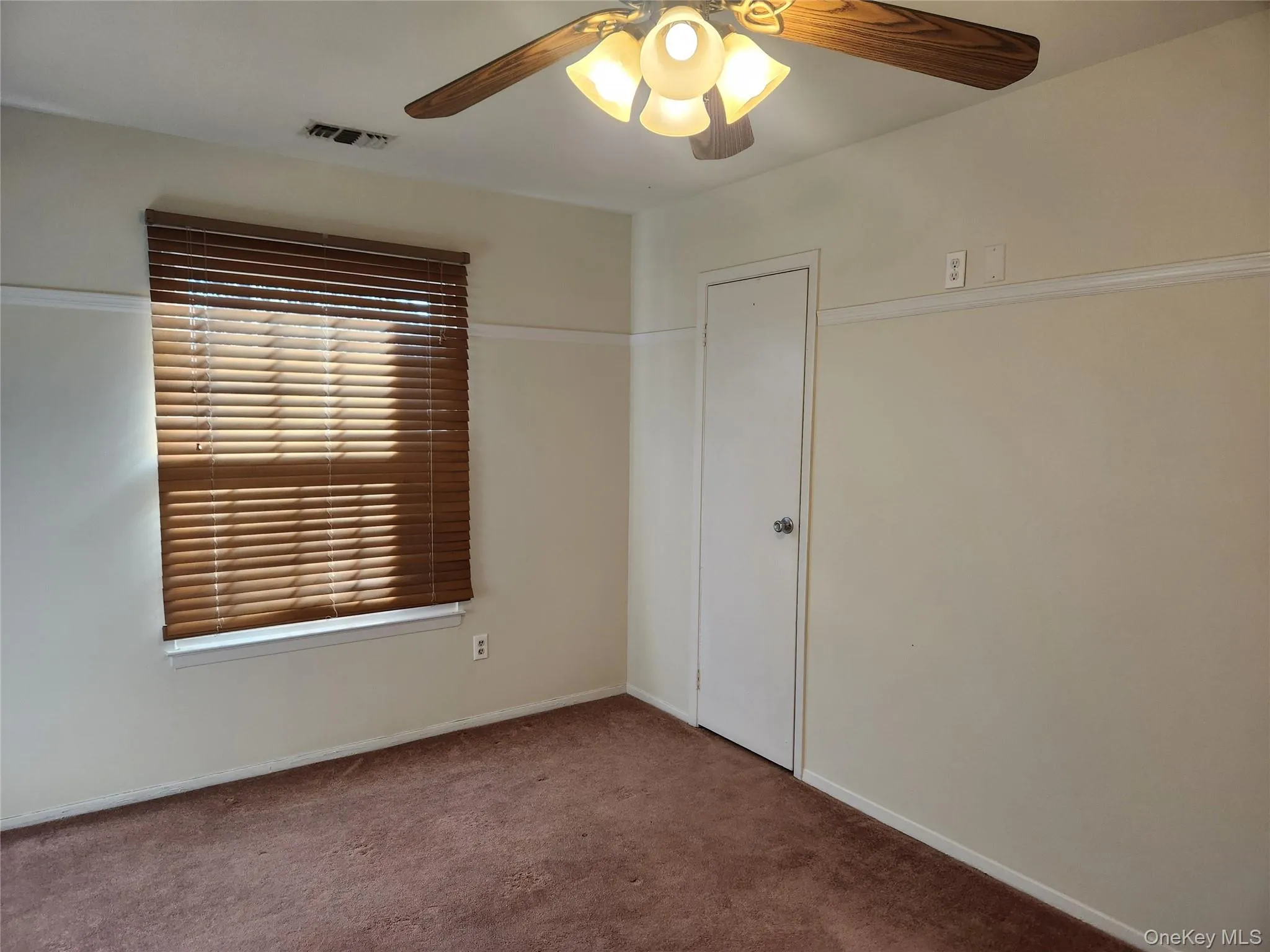 Unfurnished room featuring ceiling fan and carpet floors Unfurnished room featuring ceiling fan and carpet floors