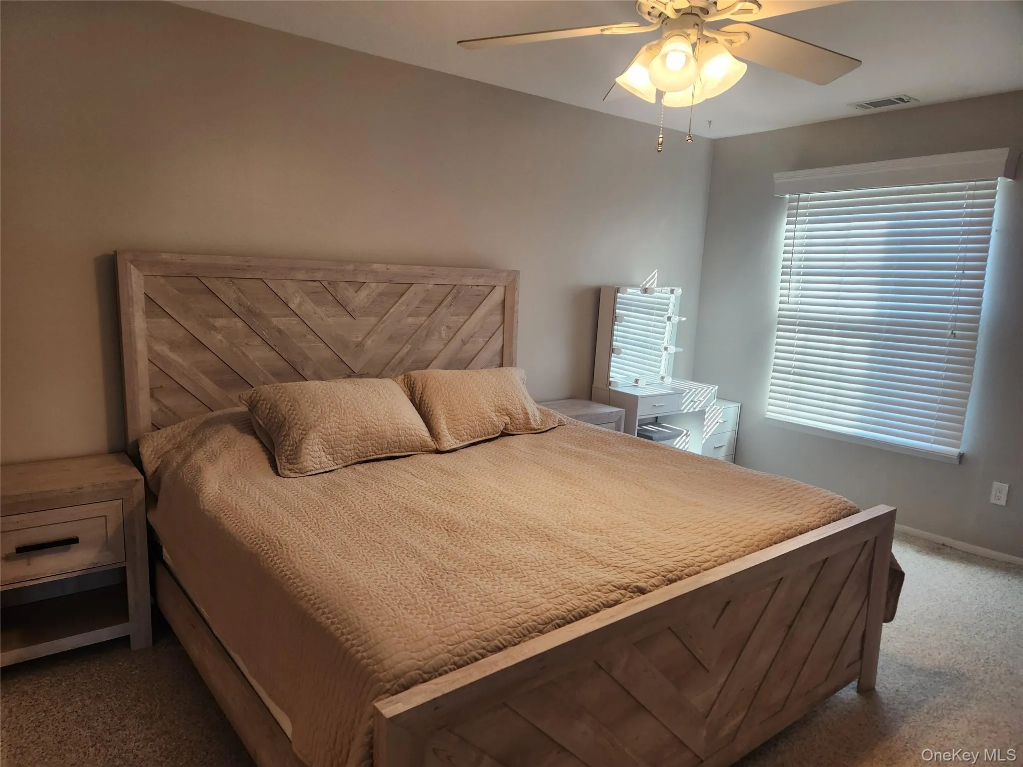Carpeted bedroom featuring ceiling fan and baseboards Carpeted bedroom featuring ceiling fan and baseboards