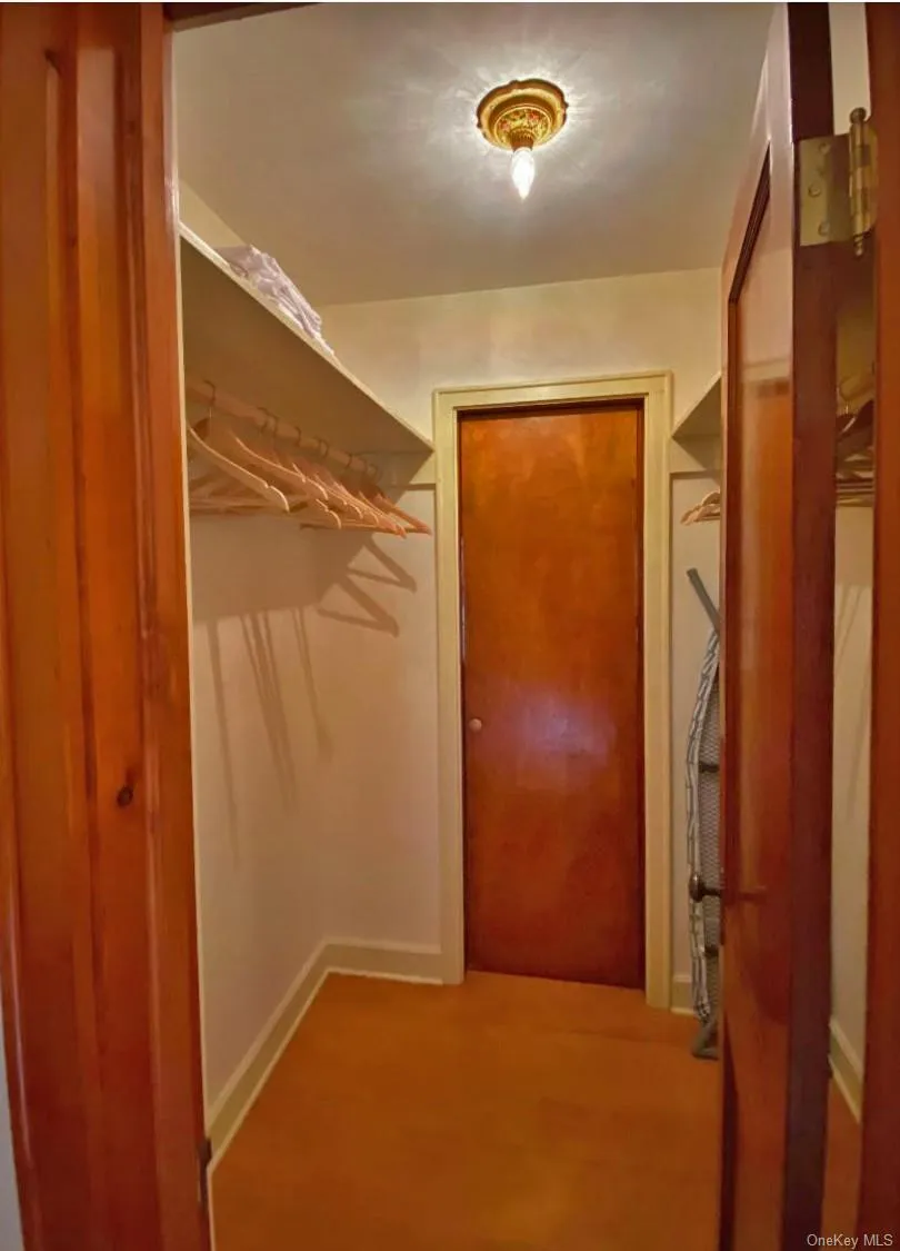 Primary Bedroom Closet with Secret Door to Bonus/Sitting Room Primary Bedroom Closet with Secret Door to Bonus/Sitting Room