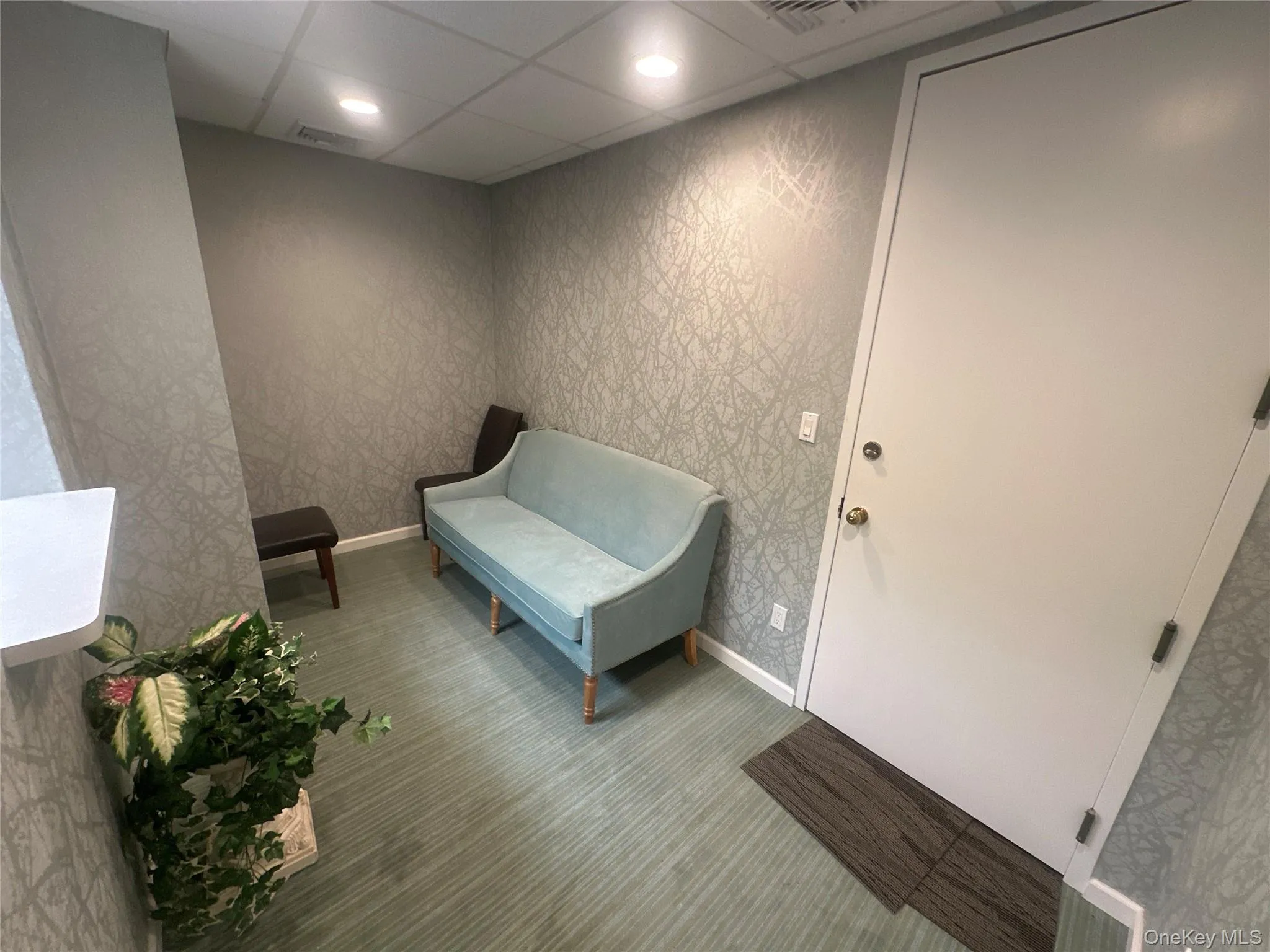 Sitting room with recessed lighting, a paneled ceiling, and wallpapered walls Sitting room with recessed lighting, a paneled ceiling, and wallpapered walls