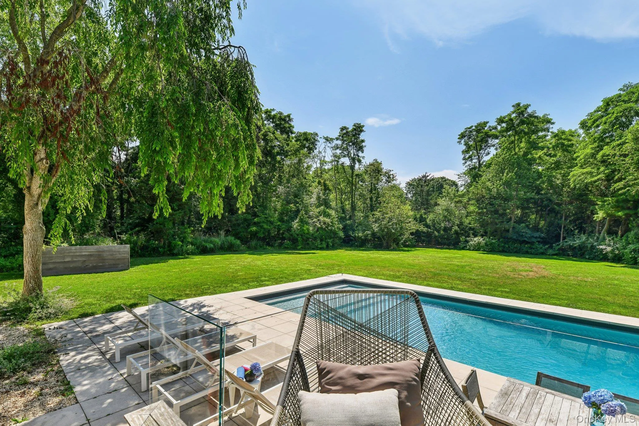 Outdoor pool featuring a patio and a yard Outdoor pool featuring a patio and a yard