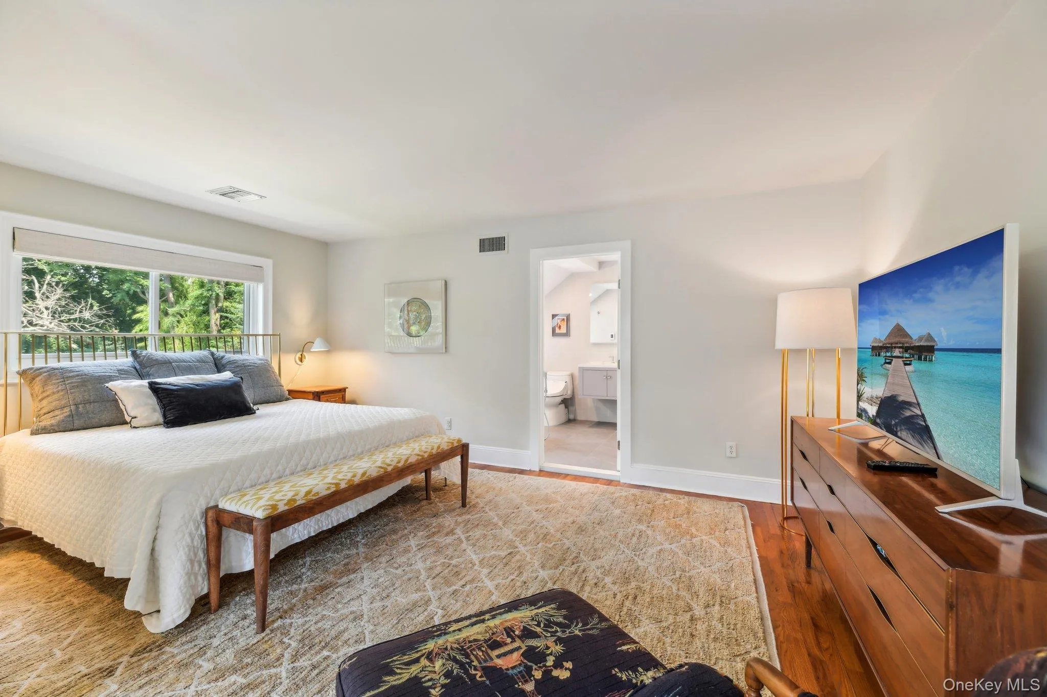 Bedroom with wood finished floors and baseboards Bedroom with wood finished floors and baseboards