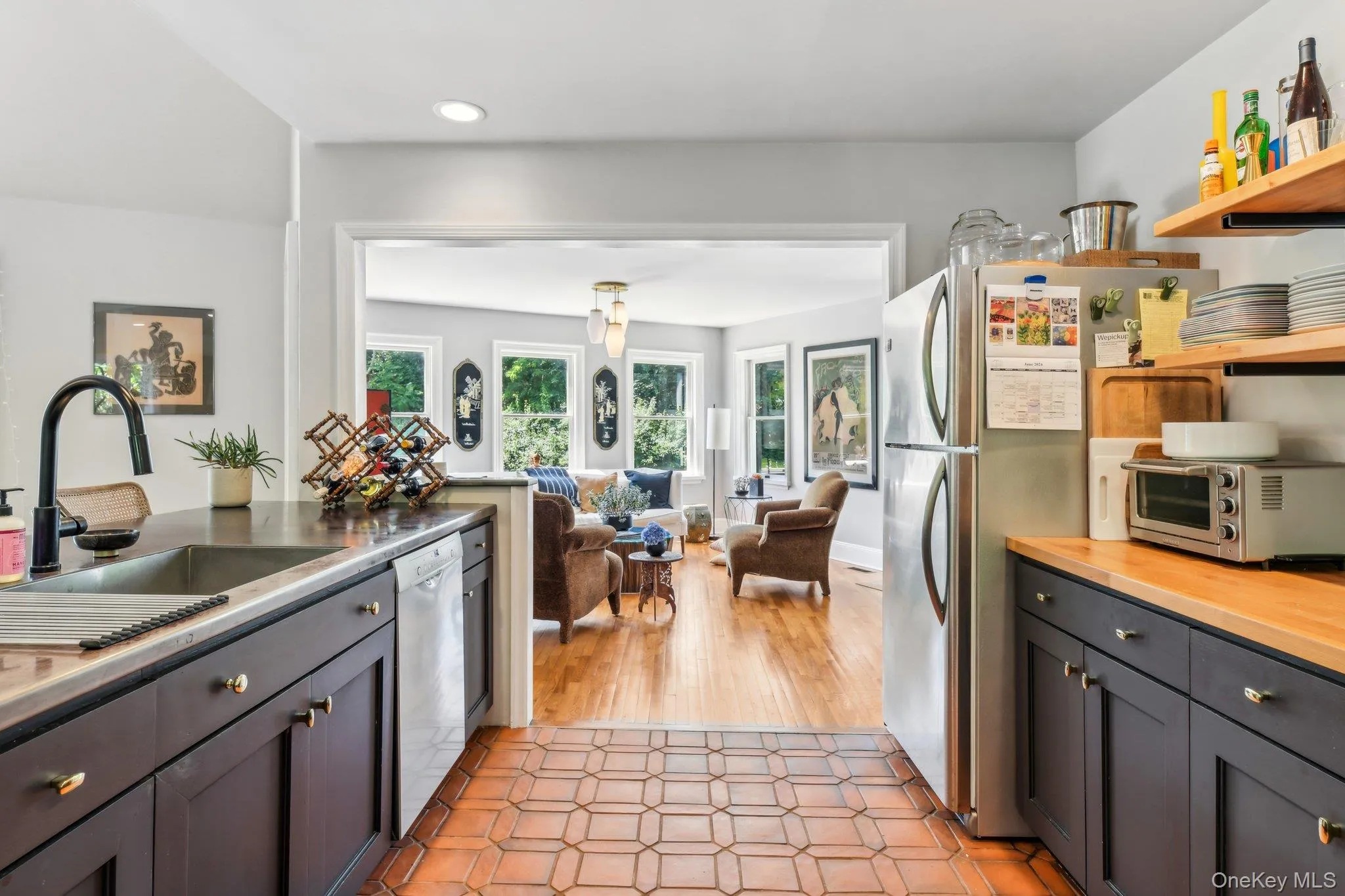 Kitchen featuring gray cabinetry, freestanding refrigerator, open shelves, and dishwasher Kitchen featuring gray cabinetry, freestanding refrigerator, open shelves, and dishwasher