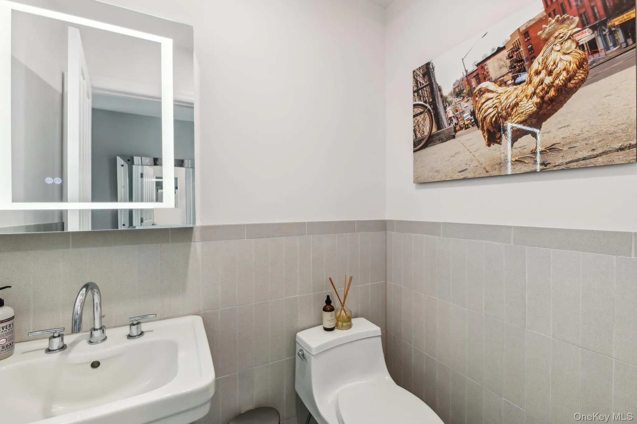 Half bath with a sink and tile walls Half bath with a sink and tile walls