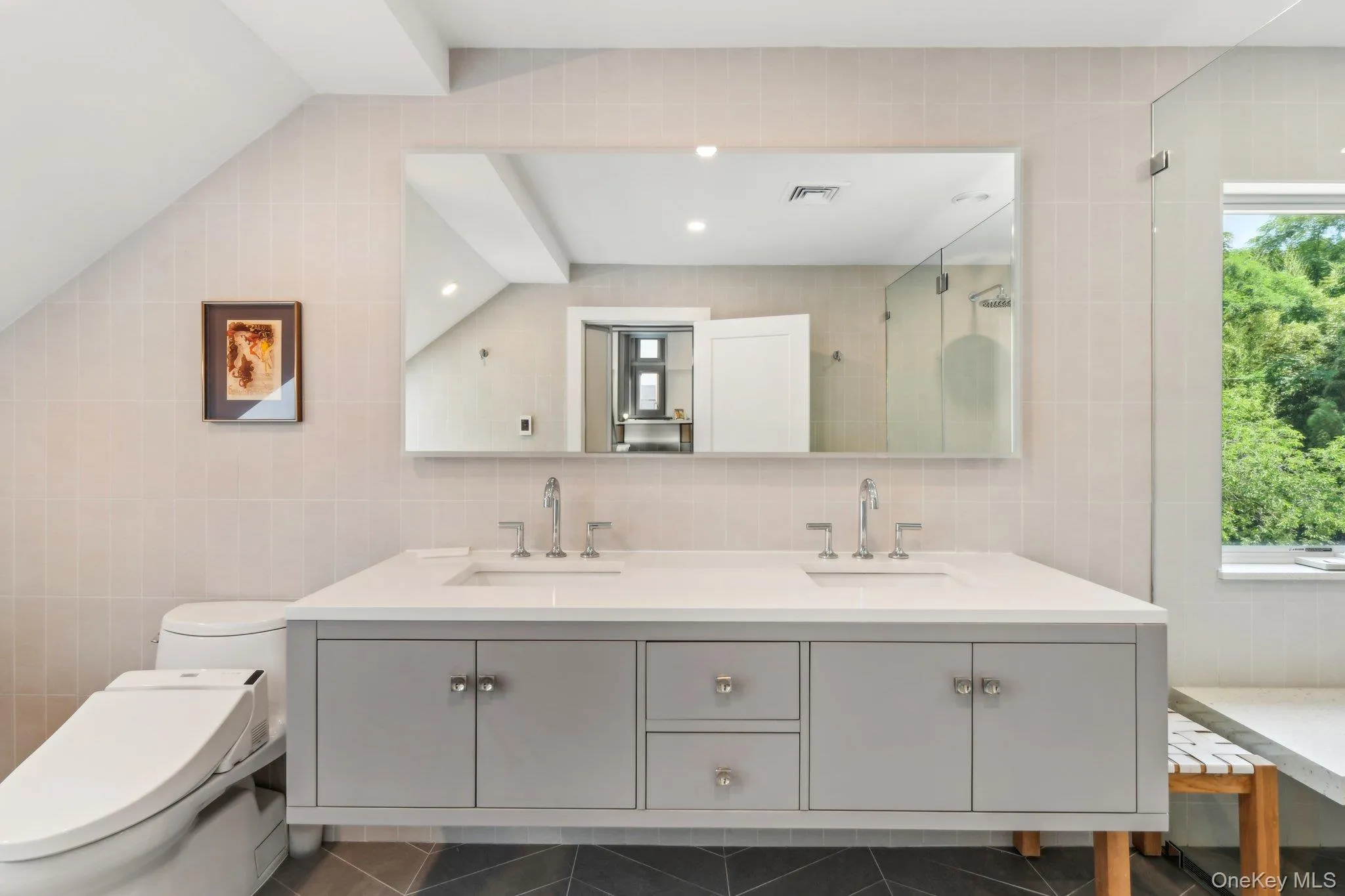 Full bathroom featuring tile walls, double vanity, and walk in shower Full bathroom featuring tile walls, double vanity, and walk in shower