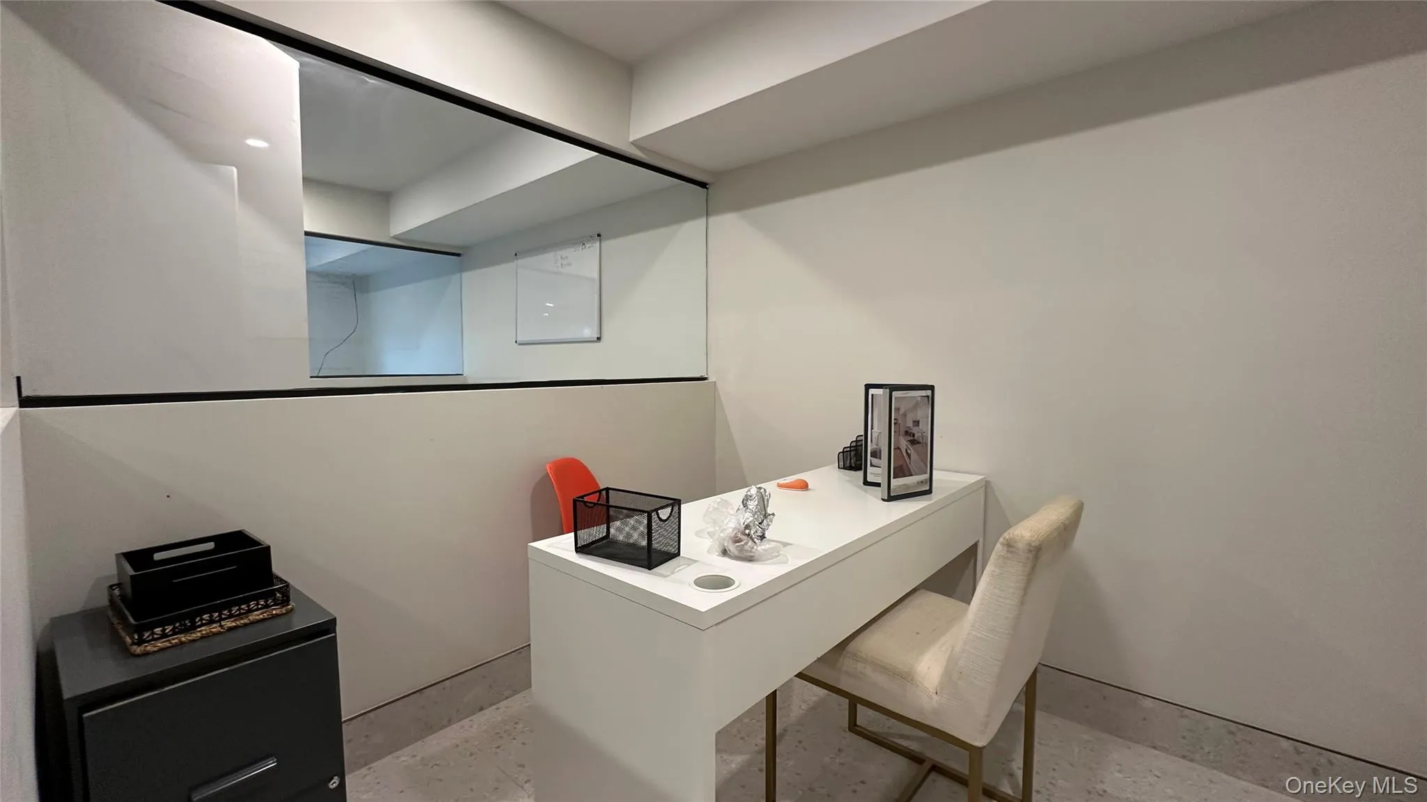 Home office featuring concrete flooring Home office featuring concrete flooring