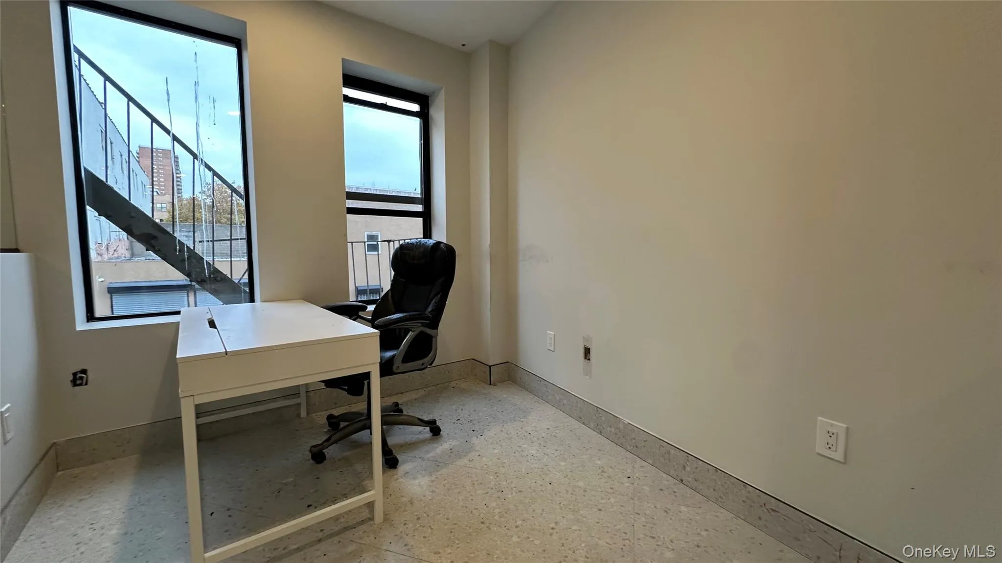 Office featuring baseboards and dark aggregate flooring Office featuring baseboards and dark aggregate flooring