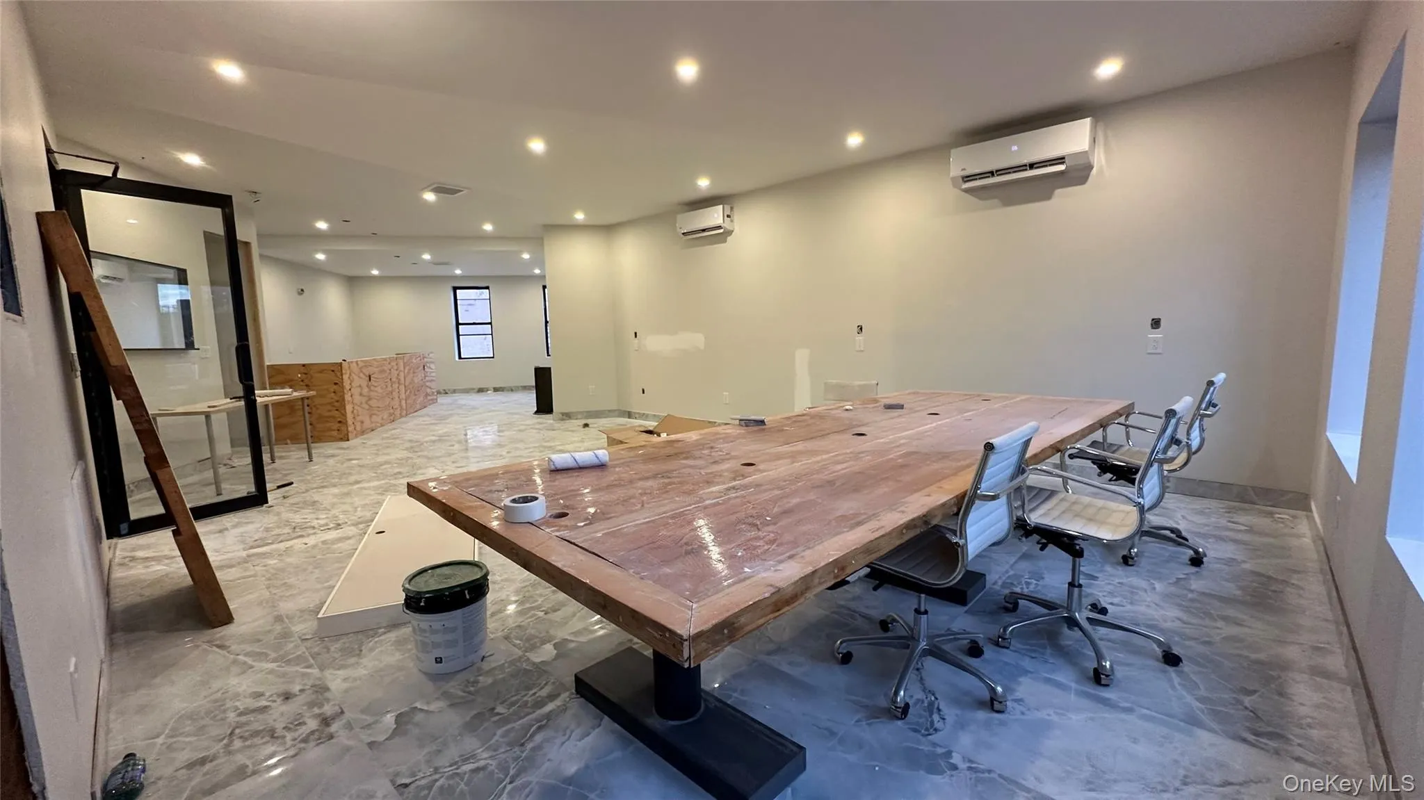 Office with recessed lighting and an AC wall unit Office with recessed lighting and an AC wall unit