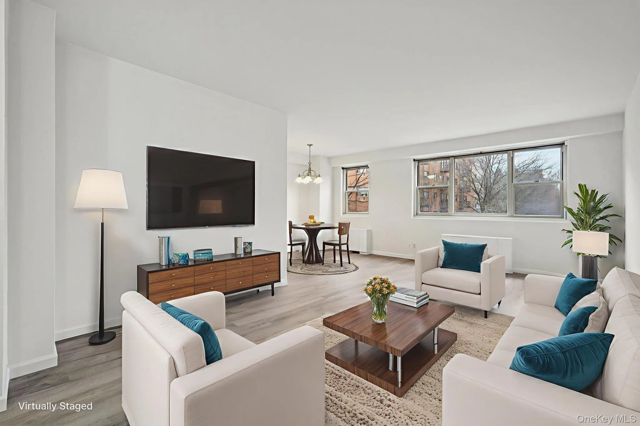 Living room with a chandelier and wood finished floors Living room with a chandelier and wood finished floors