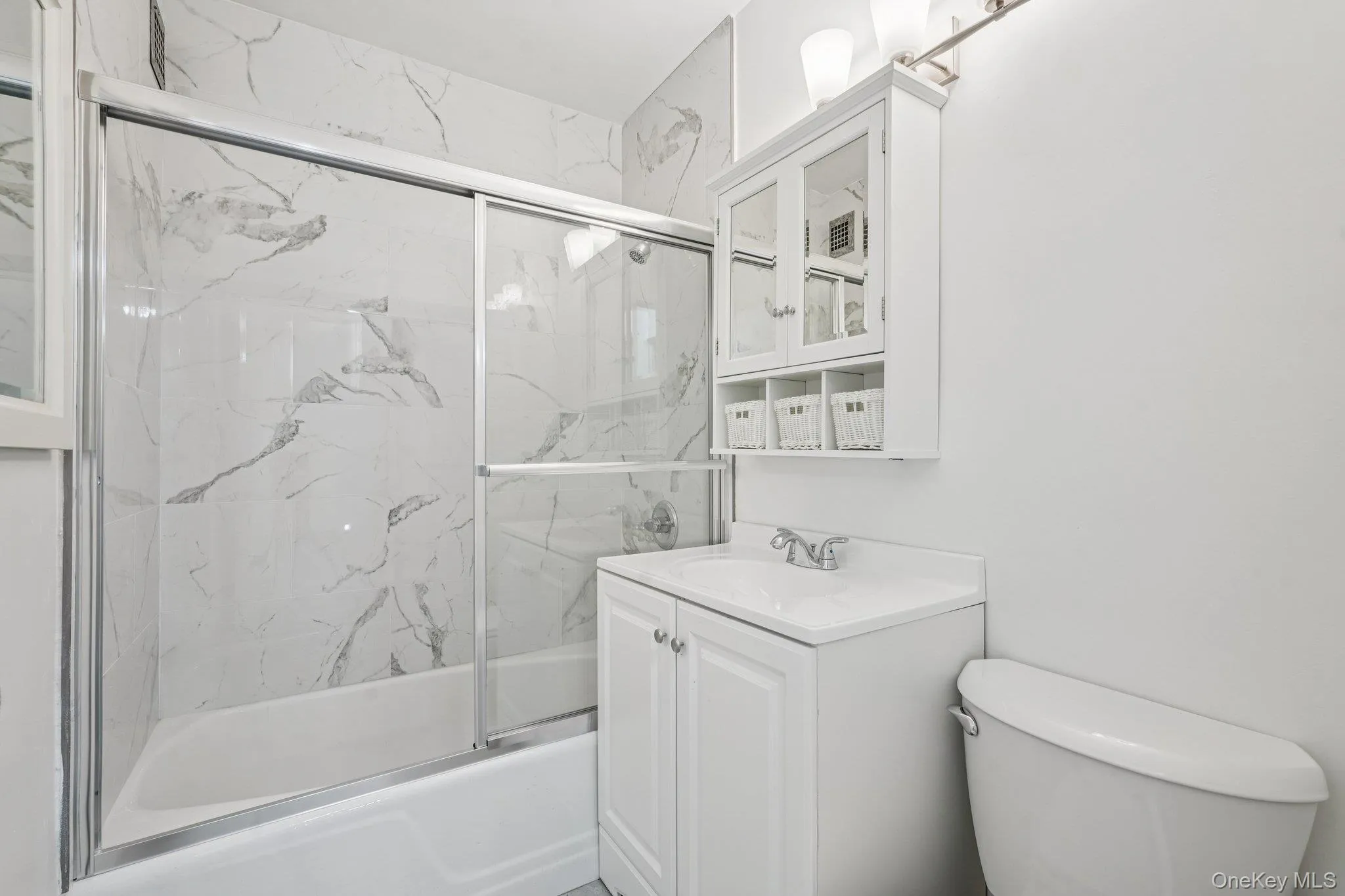 Full bathroom featuring enclosed tub / shower combo and vanity Full bathroom featuring enclosed tub / shower combo and vanity