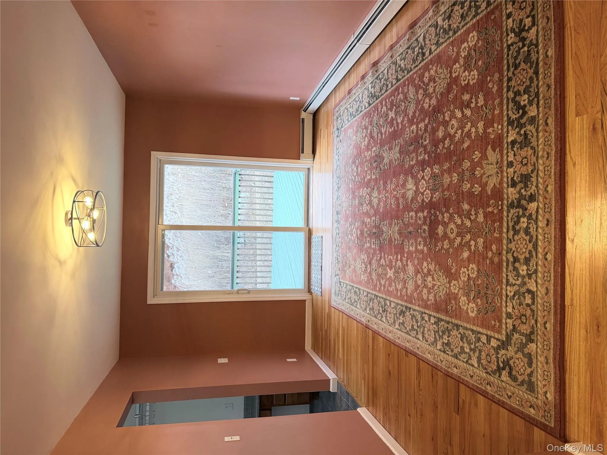 Spare room with a baseboard heating unit and light wood-style floors Spare room with a baseboard heating unit and light wood-style floors