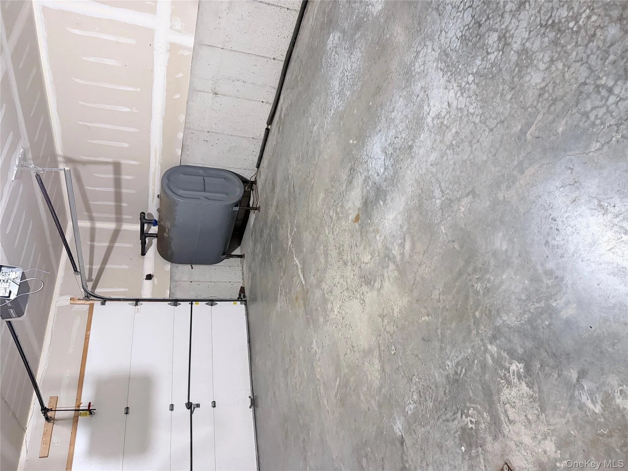 Garage featuring oil tank and a garage door opener Garage featuring oil tank and a garage door opener