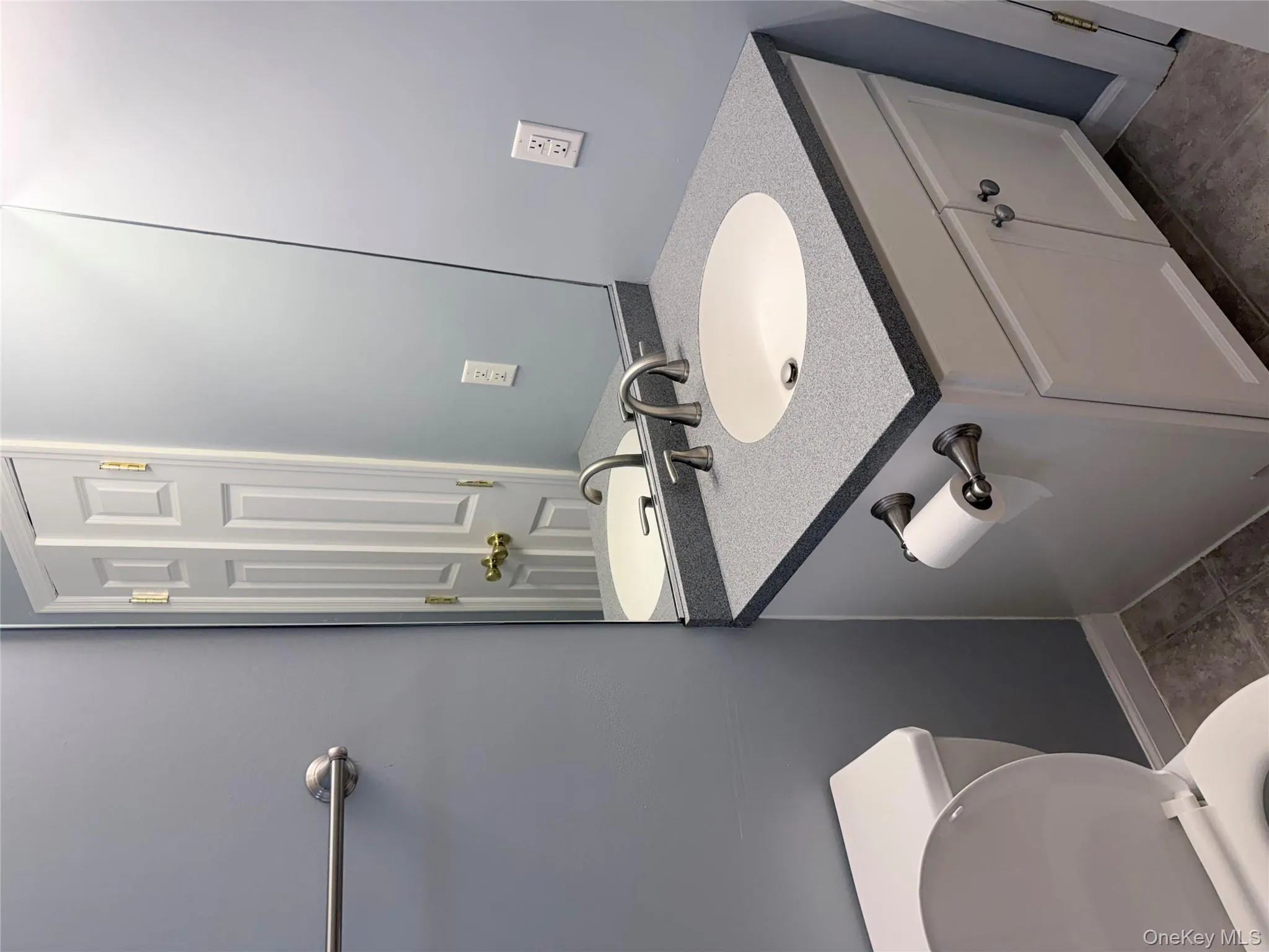 Half bathroom with vanity and tile patterned floors Half bathroom with vanity and tile patterned floors