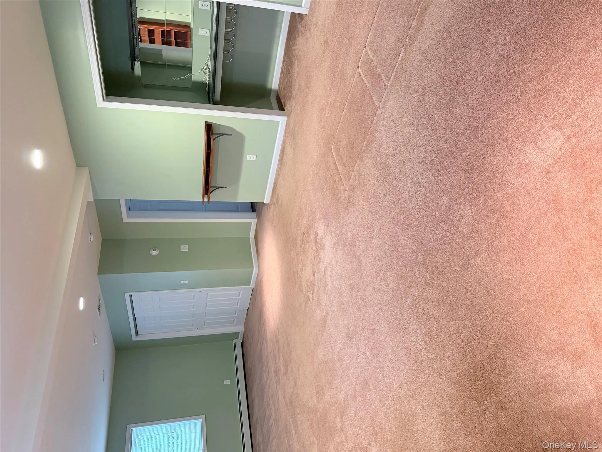 Spare room featuring light carpet, recessed lighting, and a baseboard heating unit Spare room featuring light carpet, recessed lighting, and a baseboard heating unit