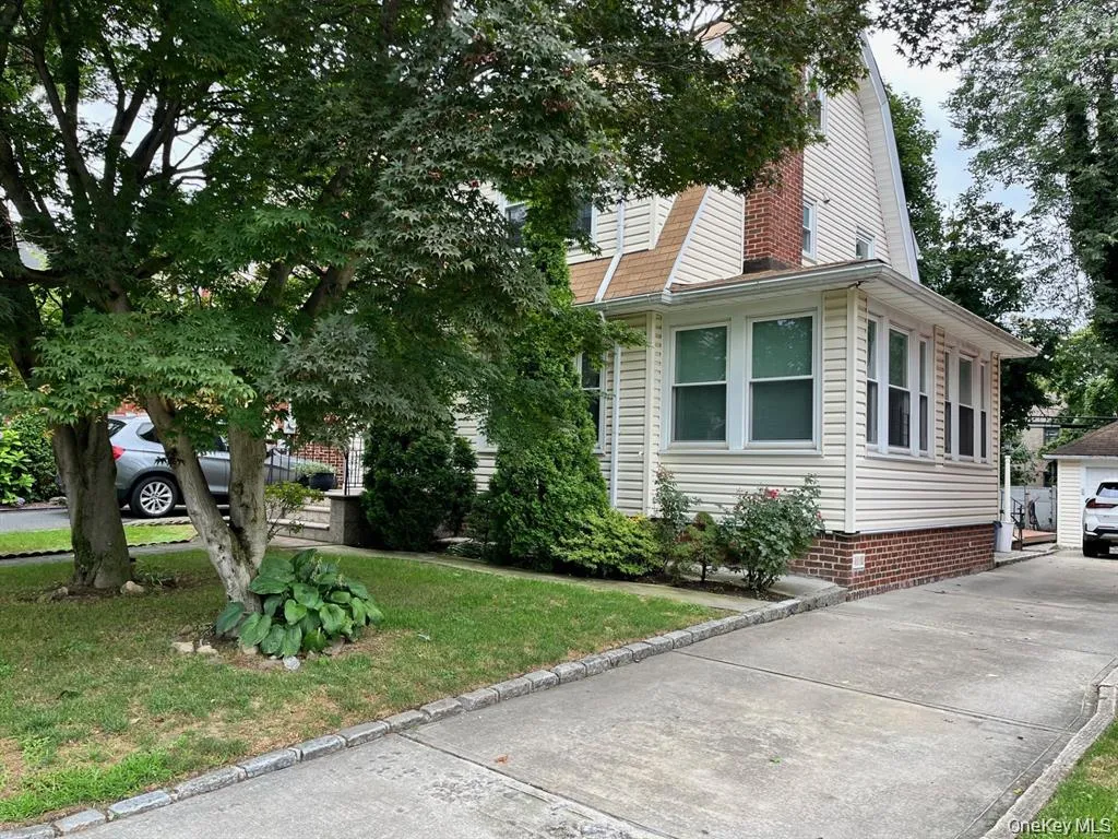 View of side of home featuring a gambrel roof, a yard, and an outdoor structure View of side of home featuring a gambrel roof, a yard, and an outdoor structure