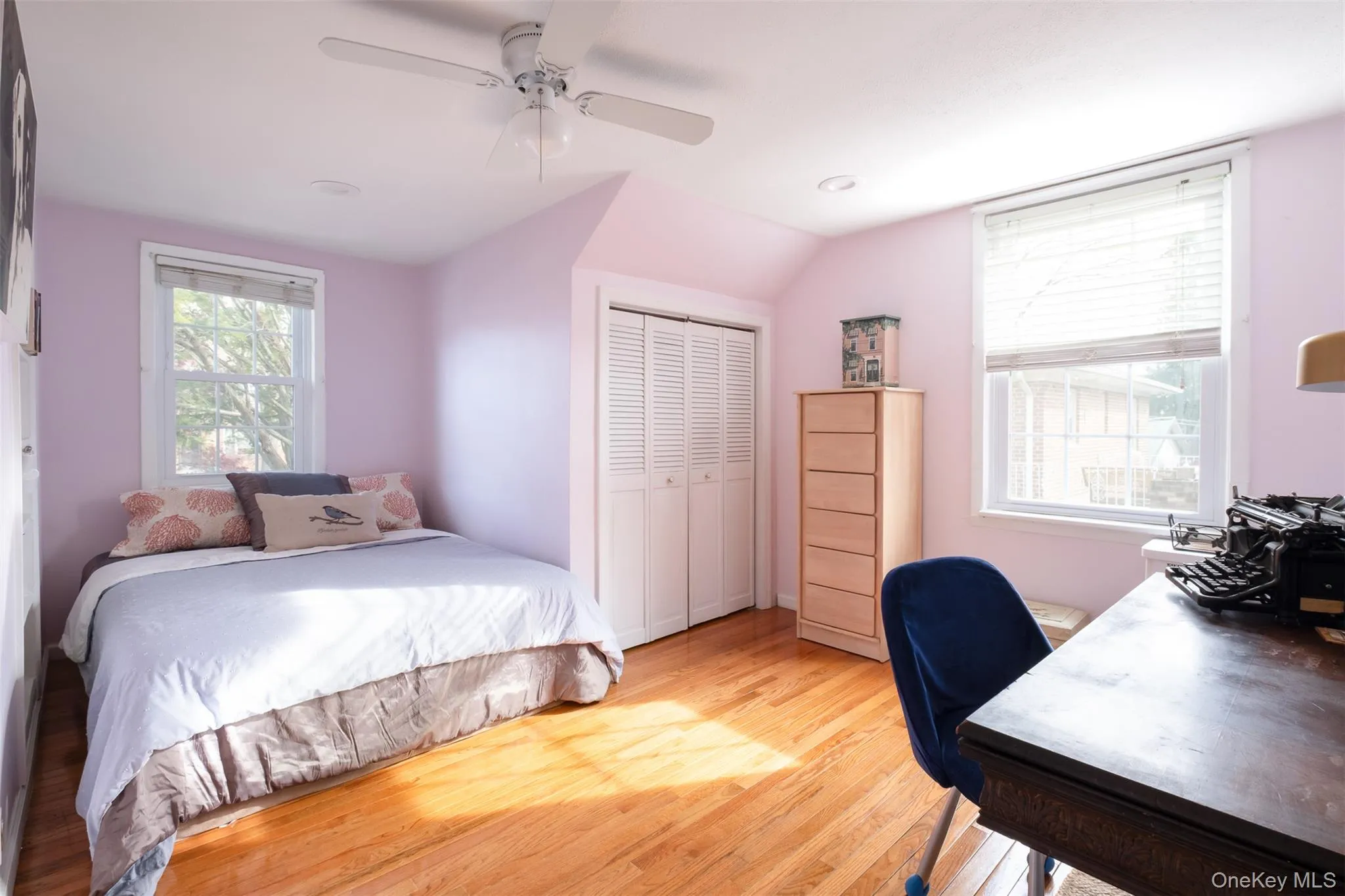 Bedroom with an office area, light wood-style floors, a closet, a ceiling fan, and lofted ceiling Bedroom with an office area, light wood-style floors, a closet, a ceiling fan, and lofted ceiling