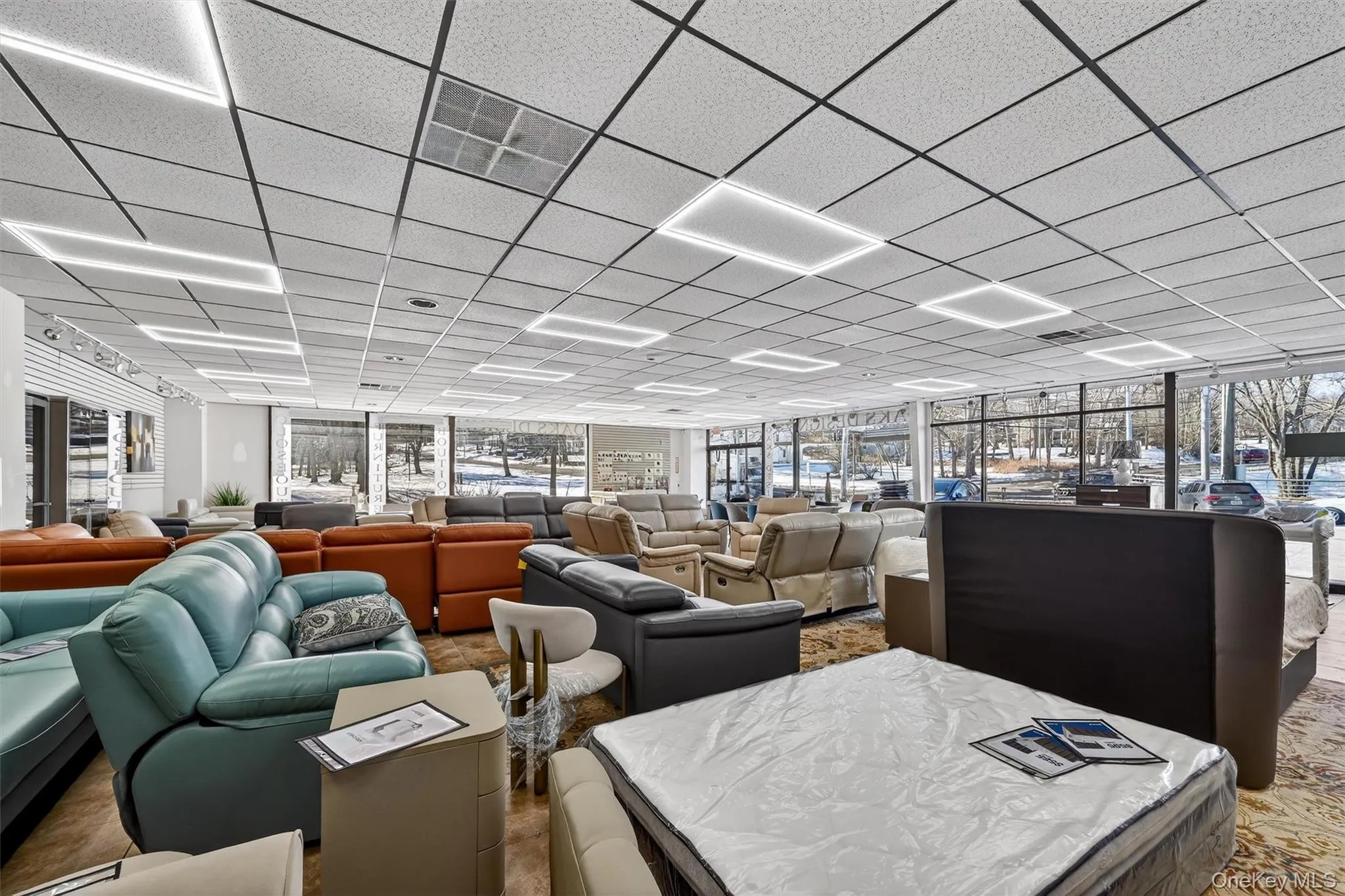 Misc room featuring a drop ceiling and healthy amount of natural light Misc room featuring a drop ceiling and healthy amount of natural light