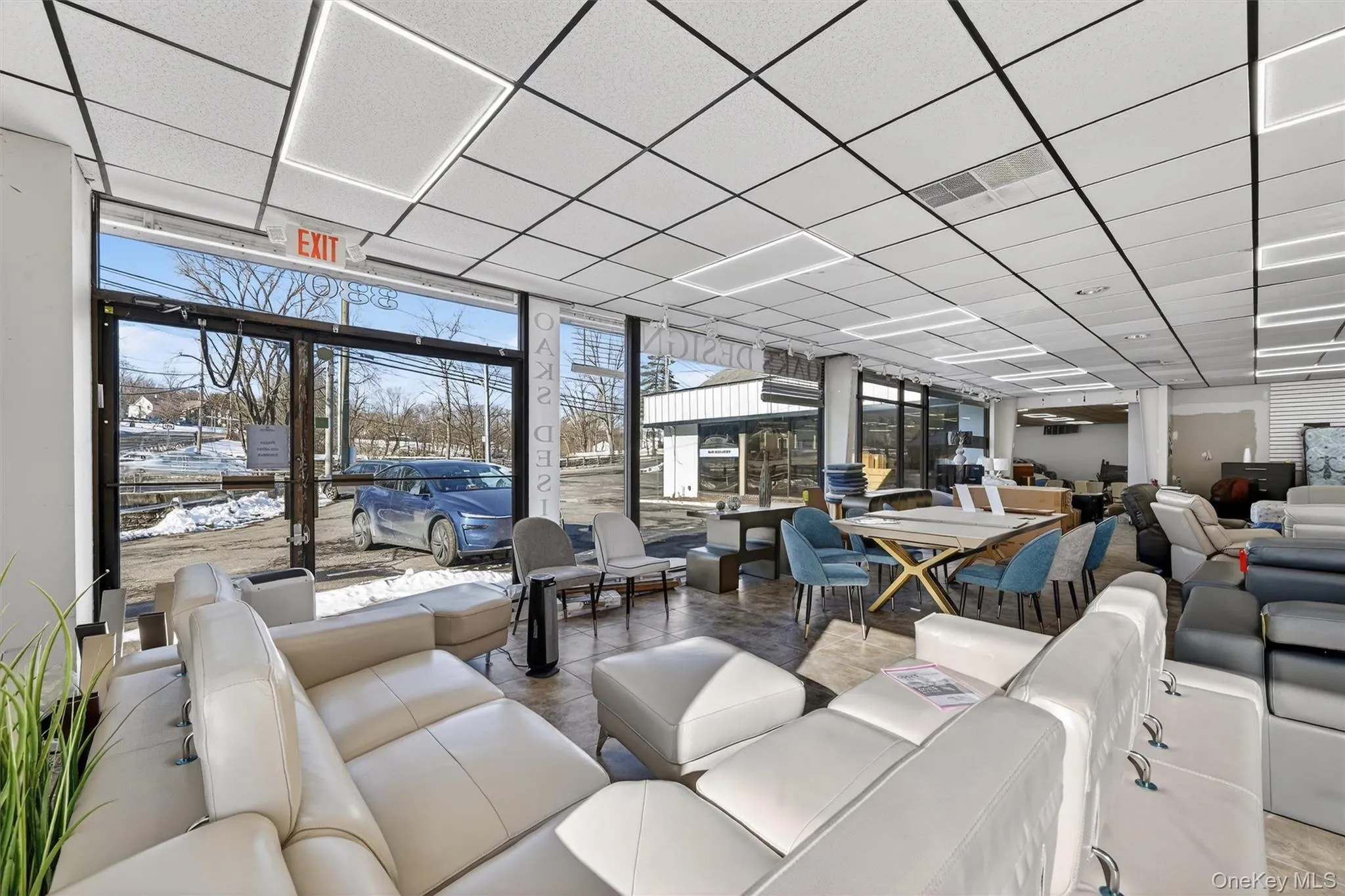 Lobby featuring a drop ceiling and floor to ceiling windows Lobby featuring a drop ceiling and floor to ceiling windows