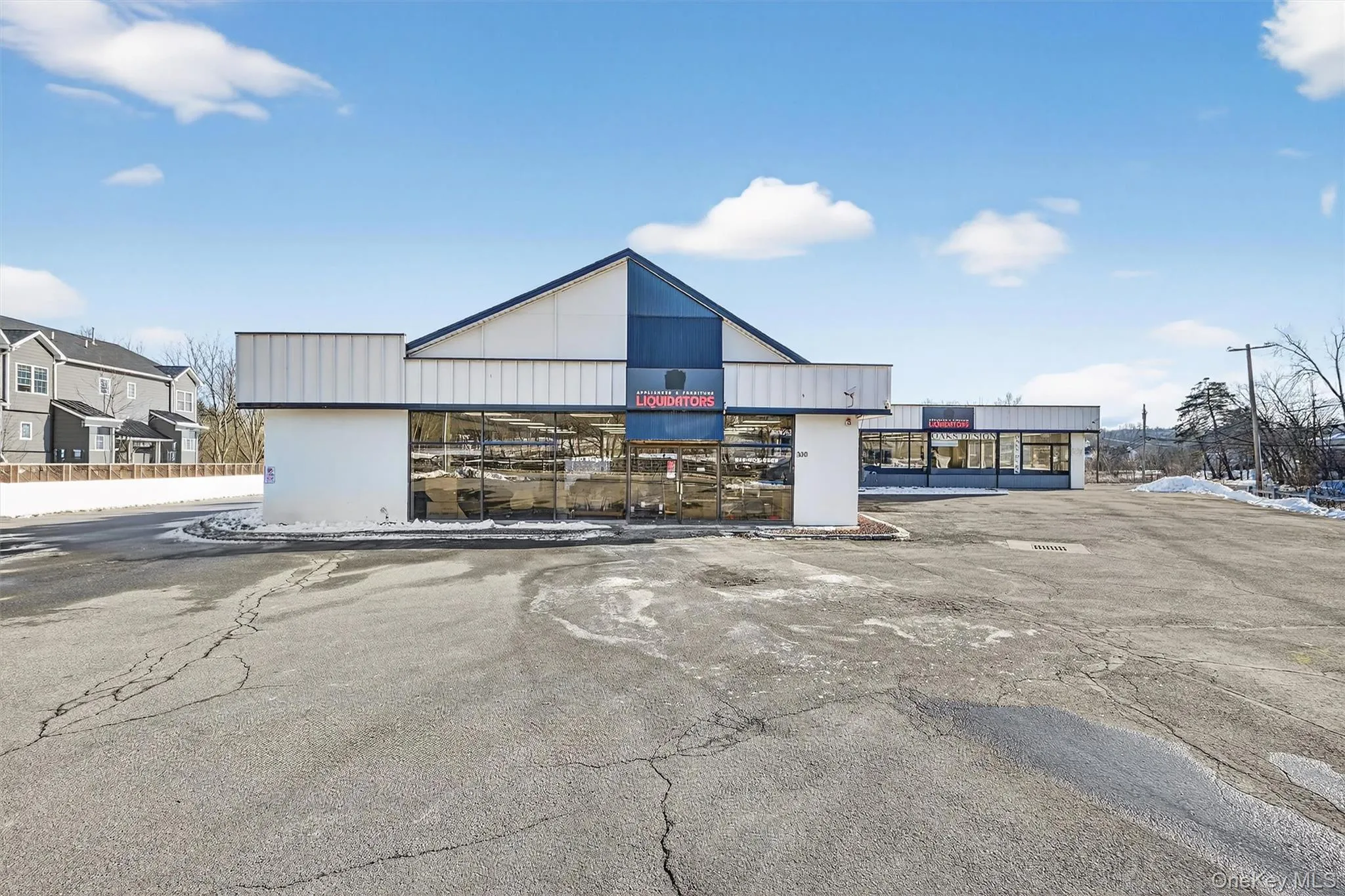 View of commercial property with uncovered parking View of commercial property with uncovered parking