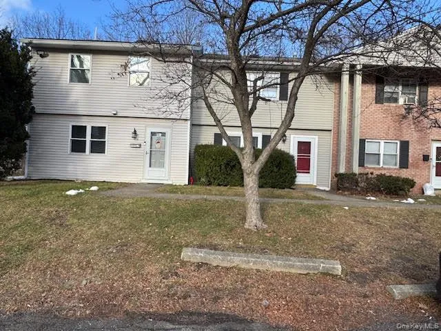 View of front facade featuring a front lawn and brick siding View of front facade featuring a front lawn and brick siding
