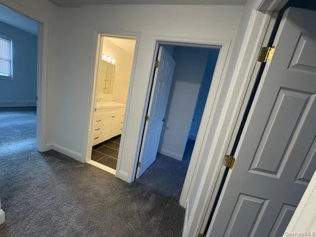 Second floor hallway with dark carpet Second floor hallway with dark carpet