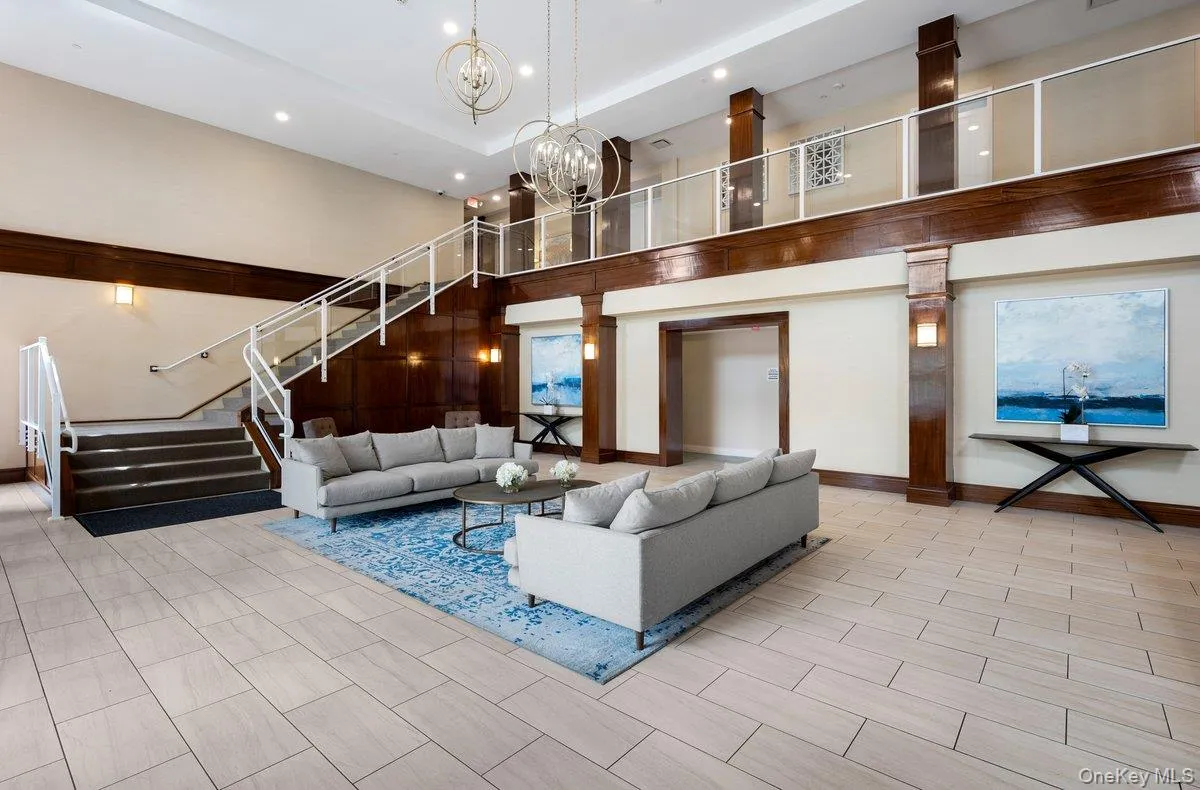 Lobby with a high ceiling, stairs, and recessed lighting Lobby with a high ceiling, stairs, and recessed lighting