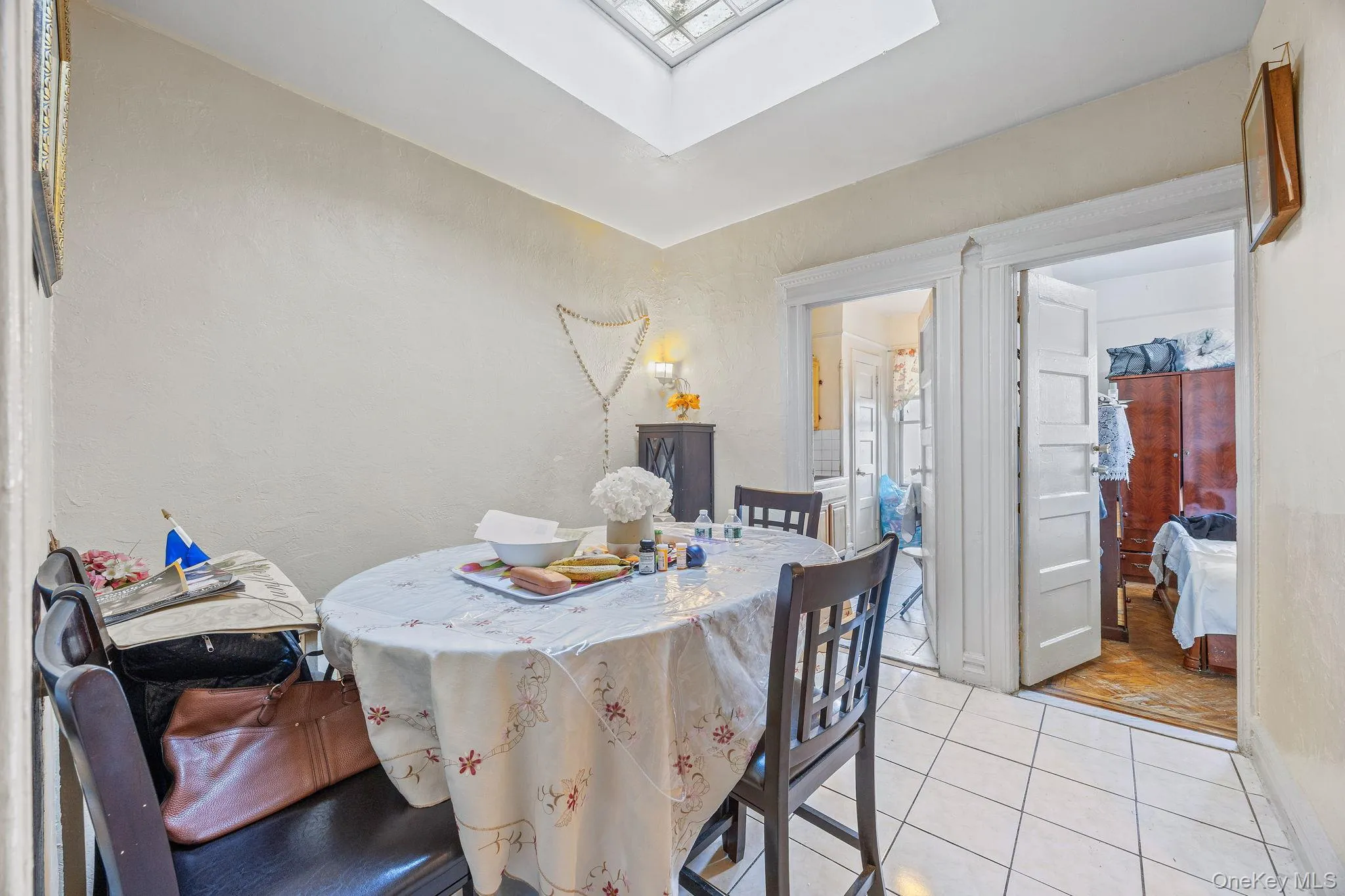 Dining space with tile patterned floors and a textured wall Dining space with tile patterned floors and a textured wall