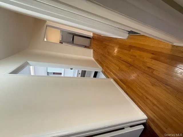 Hallway with light wood-type flooring and baseboards Hallway with light wood-type flooring and baseboards
