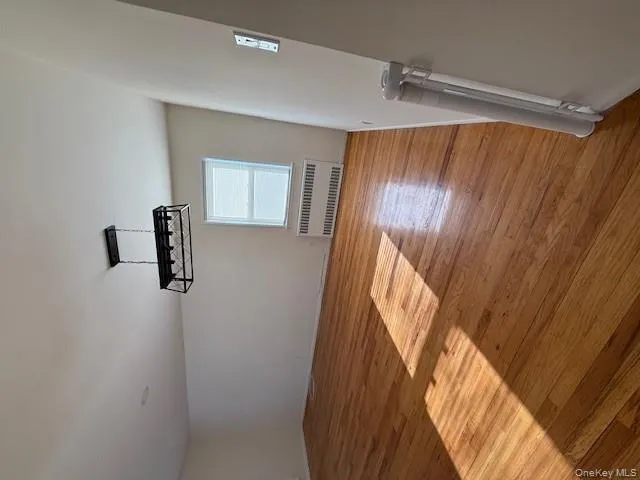 Empty room featuring radiator and light wood-style flooring Empty room featuring radiator and light wood-style flooring