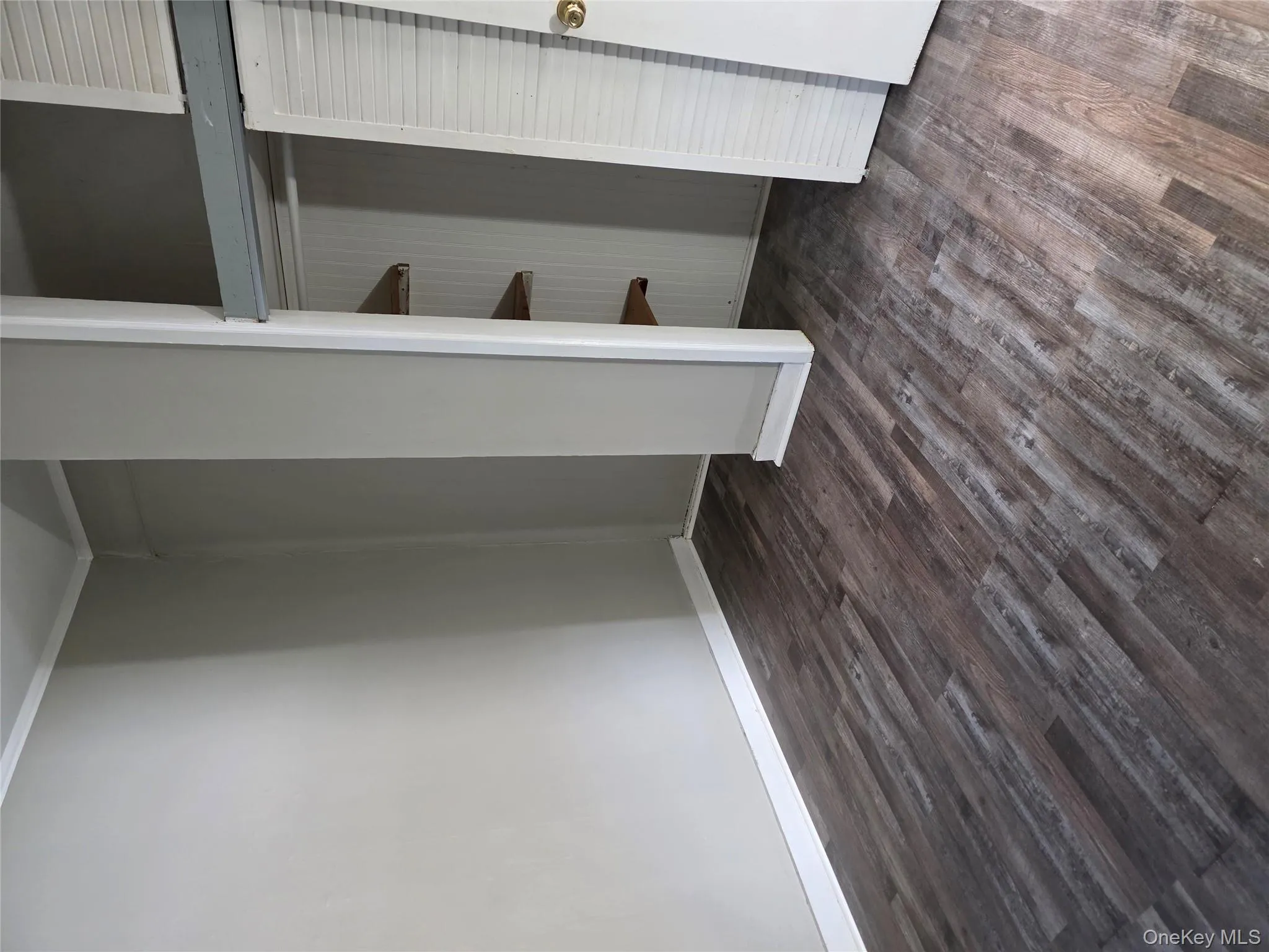 Unfurnished bedroom featuring dark wood-style flooring, a closet, and crown molding Unfurnished bedroom featuring dark wood-style flooring, a closet, and crown molding