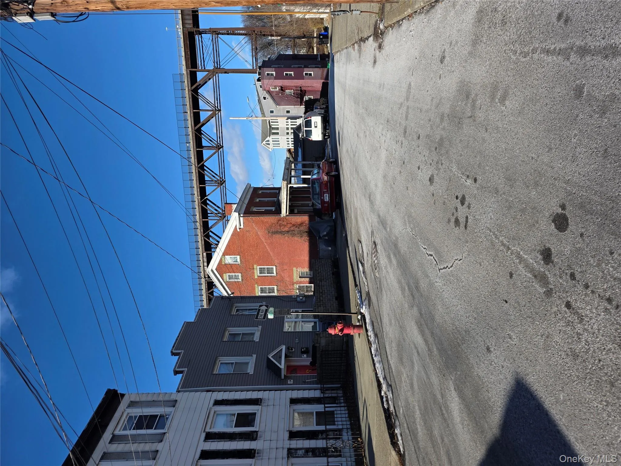 View of asphalt road with curbs and sidewalks View of asphalt road with curbs and sidewalks