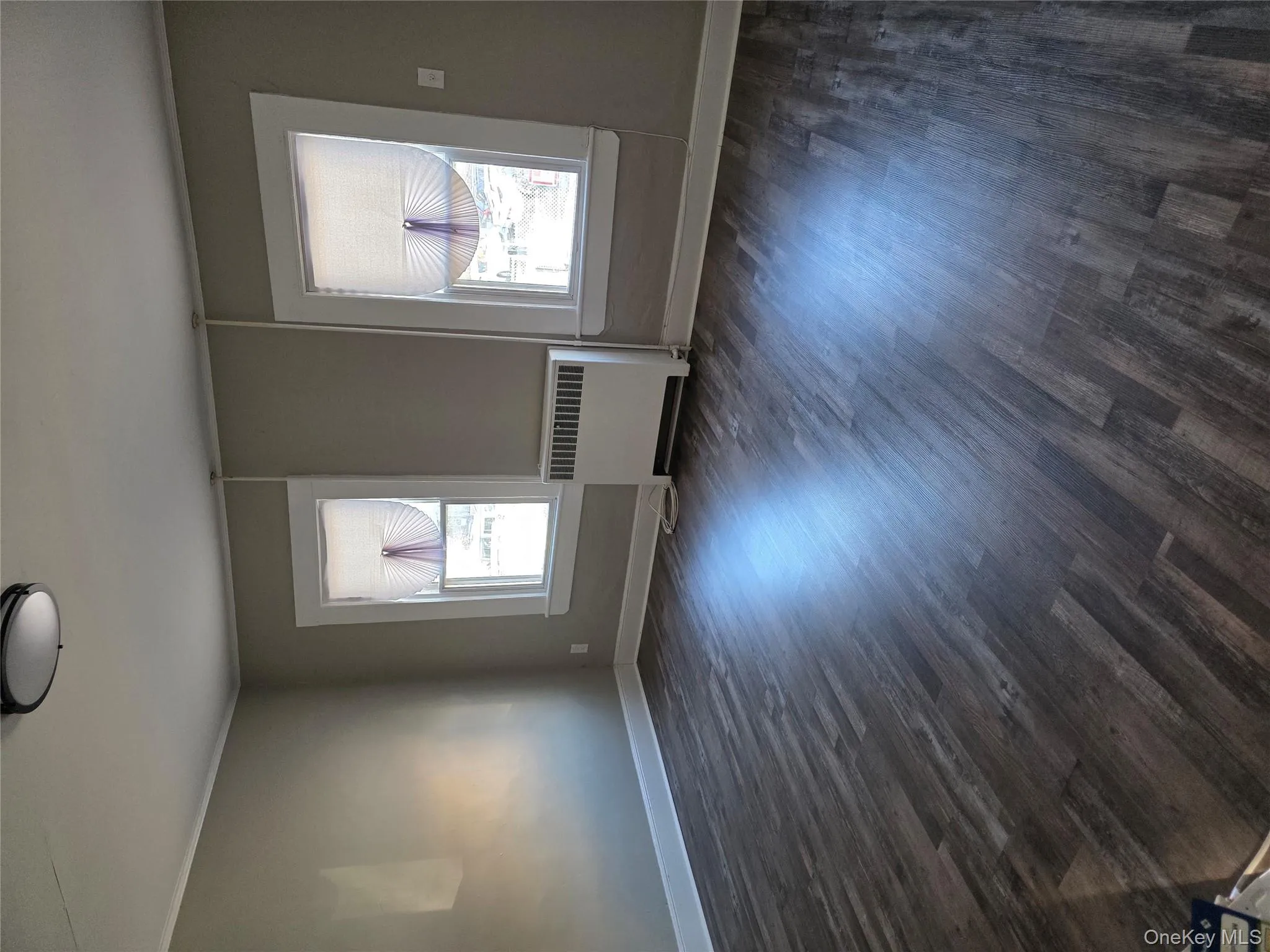 Unfurnished room with radiator heating unit, dark wood-style flooring, and crown molding Unfurnished room with radiator heating unit, dark wood-style flooring, and crown molding