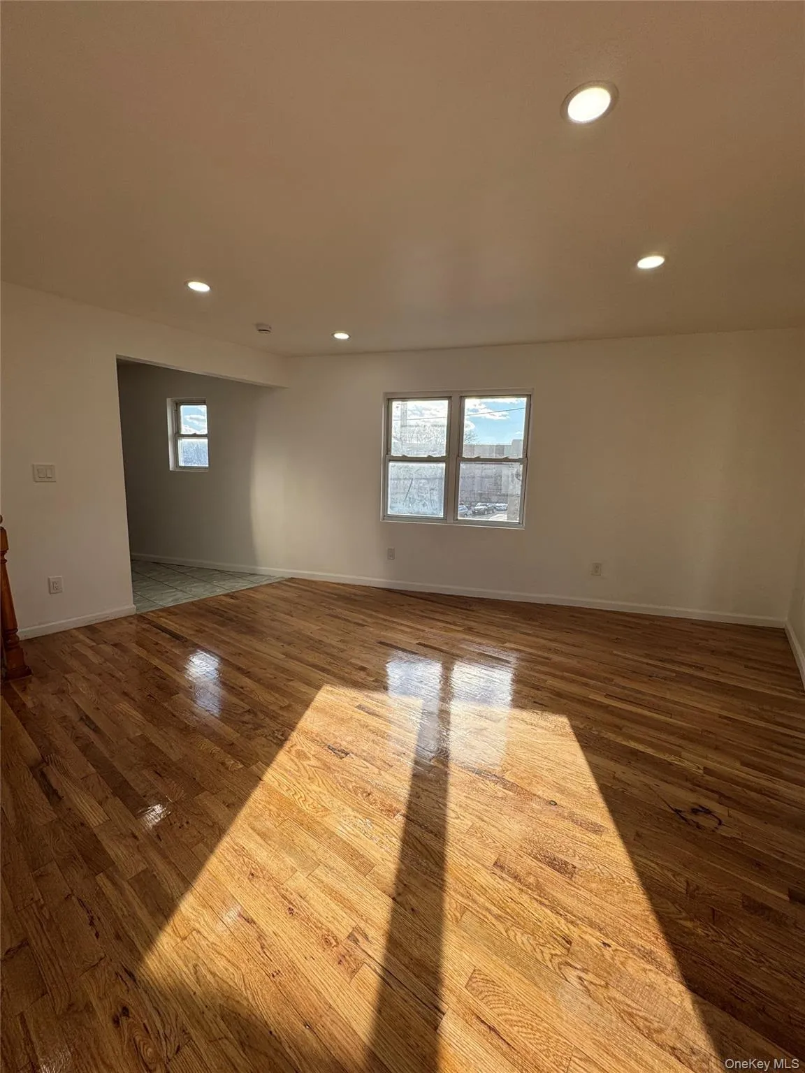 Empty room with recessed lighting, dark wood-style floors, and healthy amount of natural light Empty room with recessed lighting, dark wood-style floors, and healthy amount of natural light