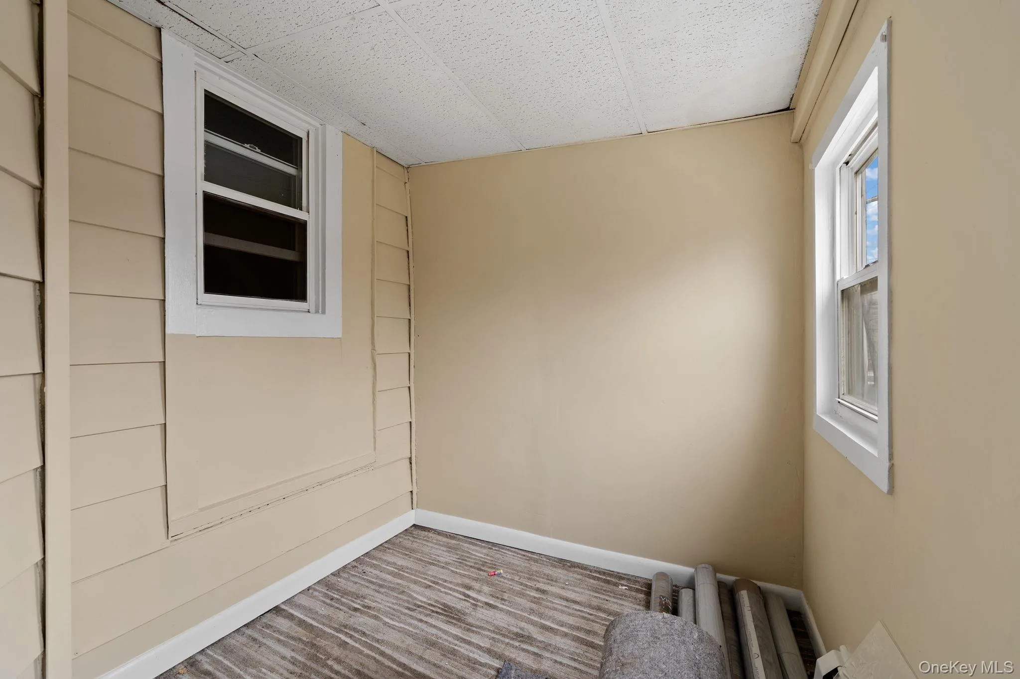 Unfurnished room with baseboards and wood finished floors Unfurnished room with baseboards and wood finished floors